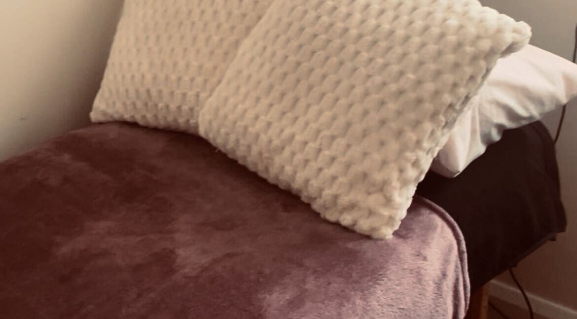 Relaxing treatment bed at Kilkenny Acupuncture Clinic, Kilkenny, County Kilkenny, IE with soft pillows.