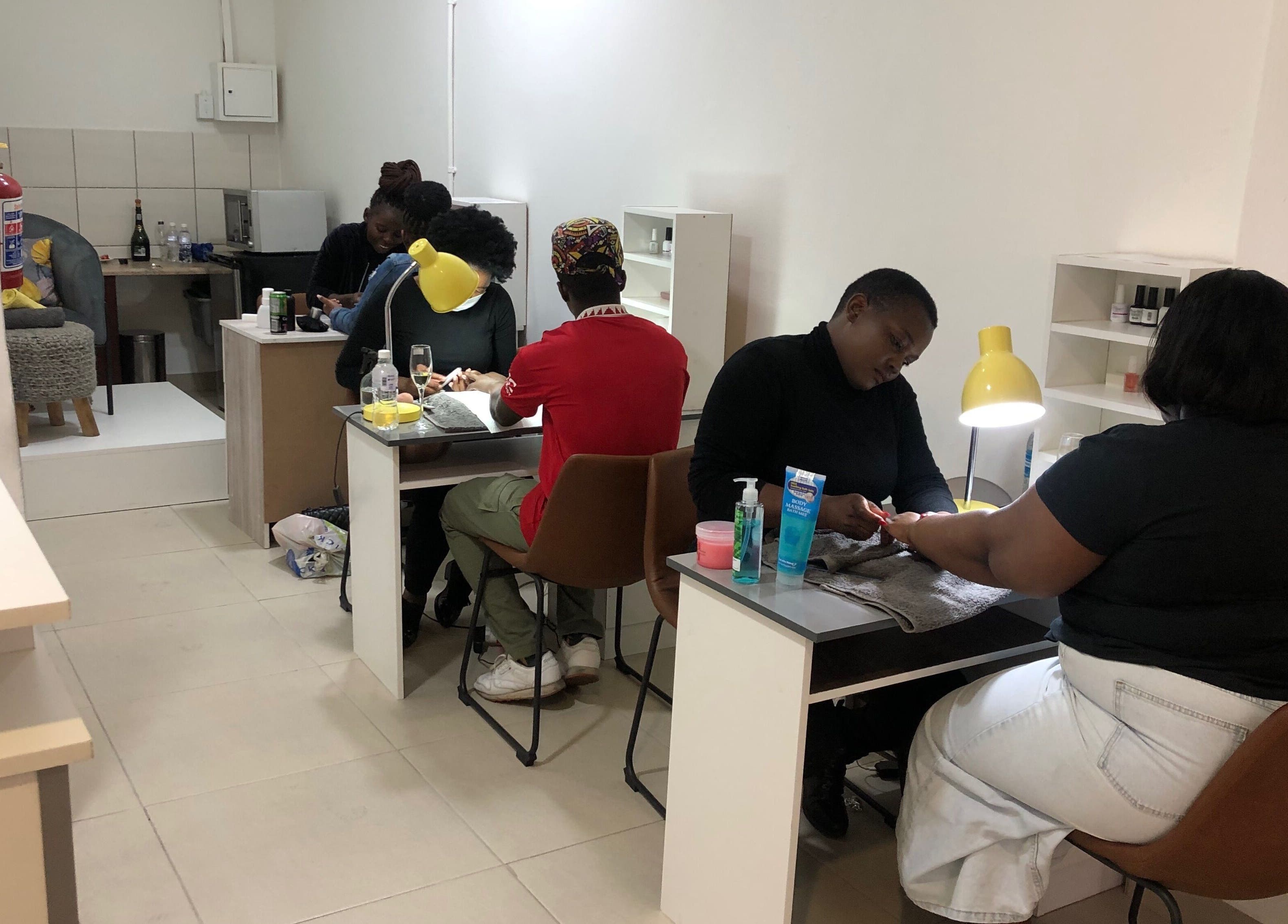 Clients enjoy nail care at Le Clouer, Kempton Park, Gauteng, ZA. Bright, inviting ambience enhances relaxation.