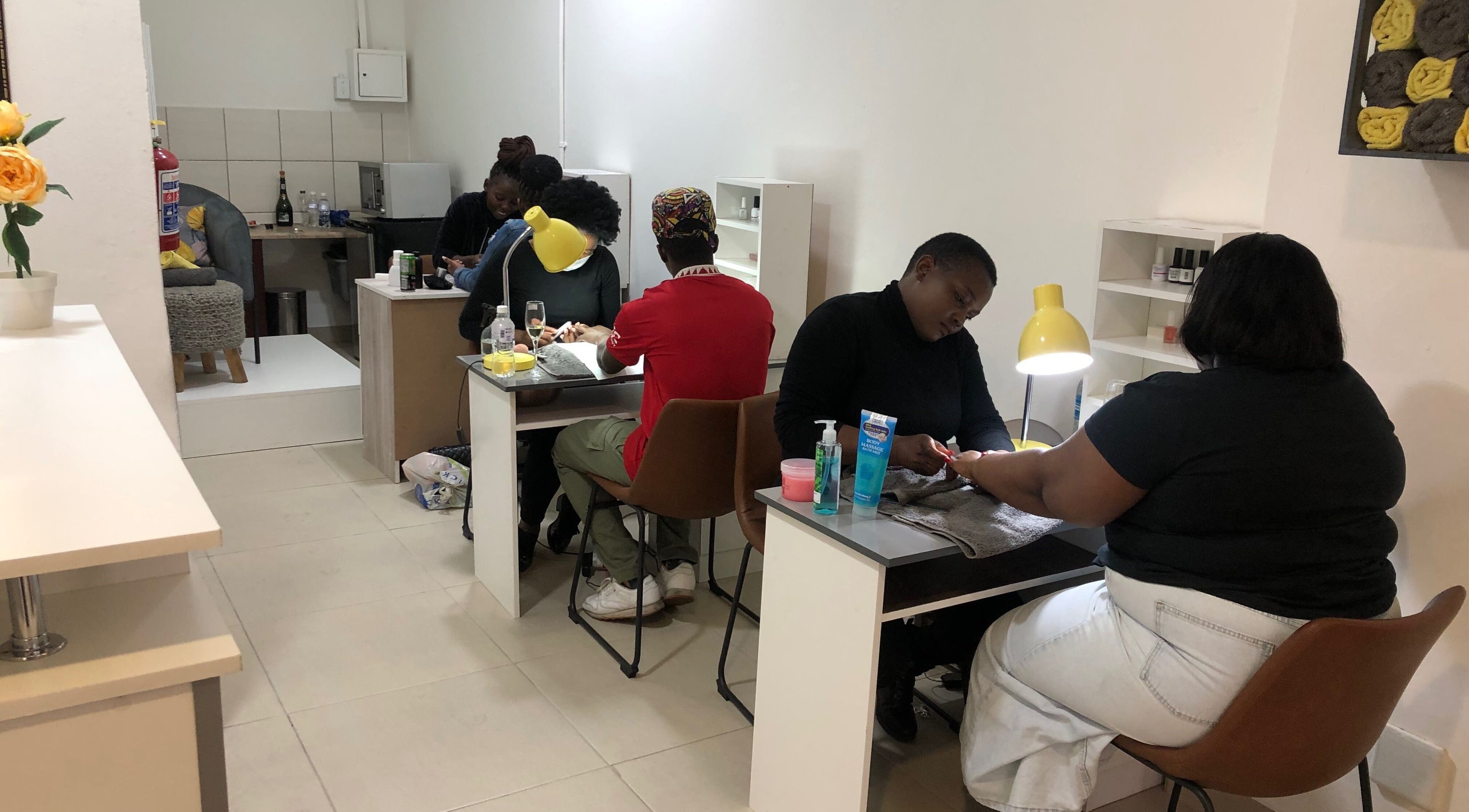 Clients enjoy nail care at Le Clouer, Kempton Park, Gauteng, ZA. Bright, inviting ambience enhances relaxation.