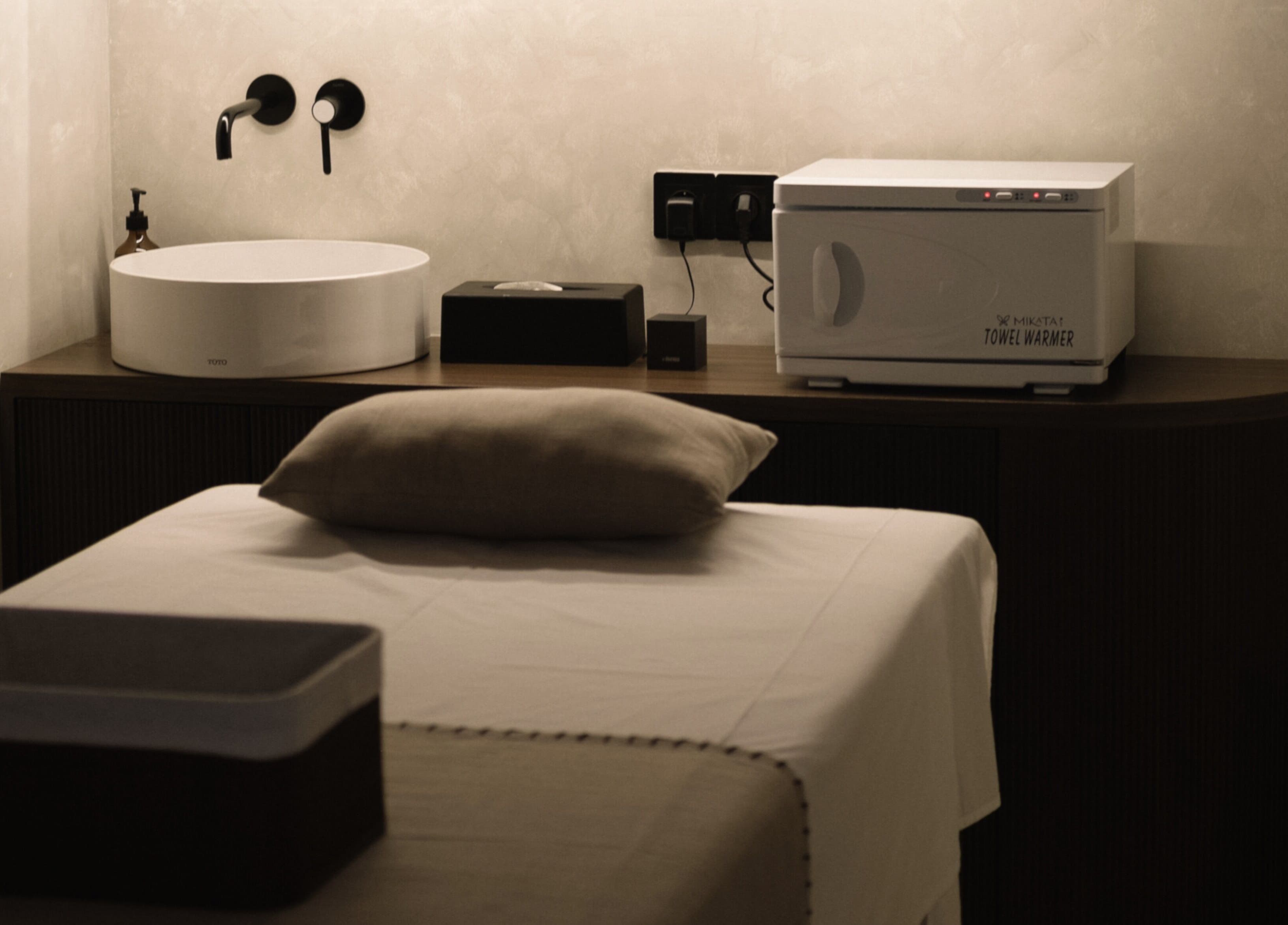 Tranquil spa room at Saya Holistic Spa in Bali, Bali, ID featuring a massage table and warm ambience.