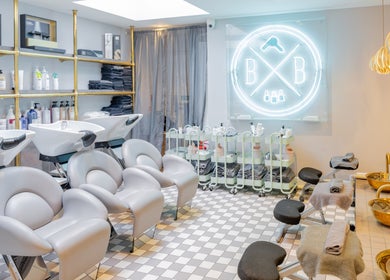 Blush + Blow London salon's elegant interior in London, England, GB, featuring modern styling stations and chic decor.