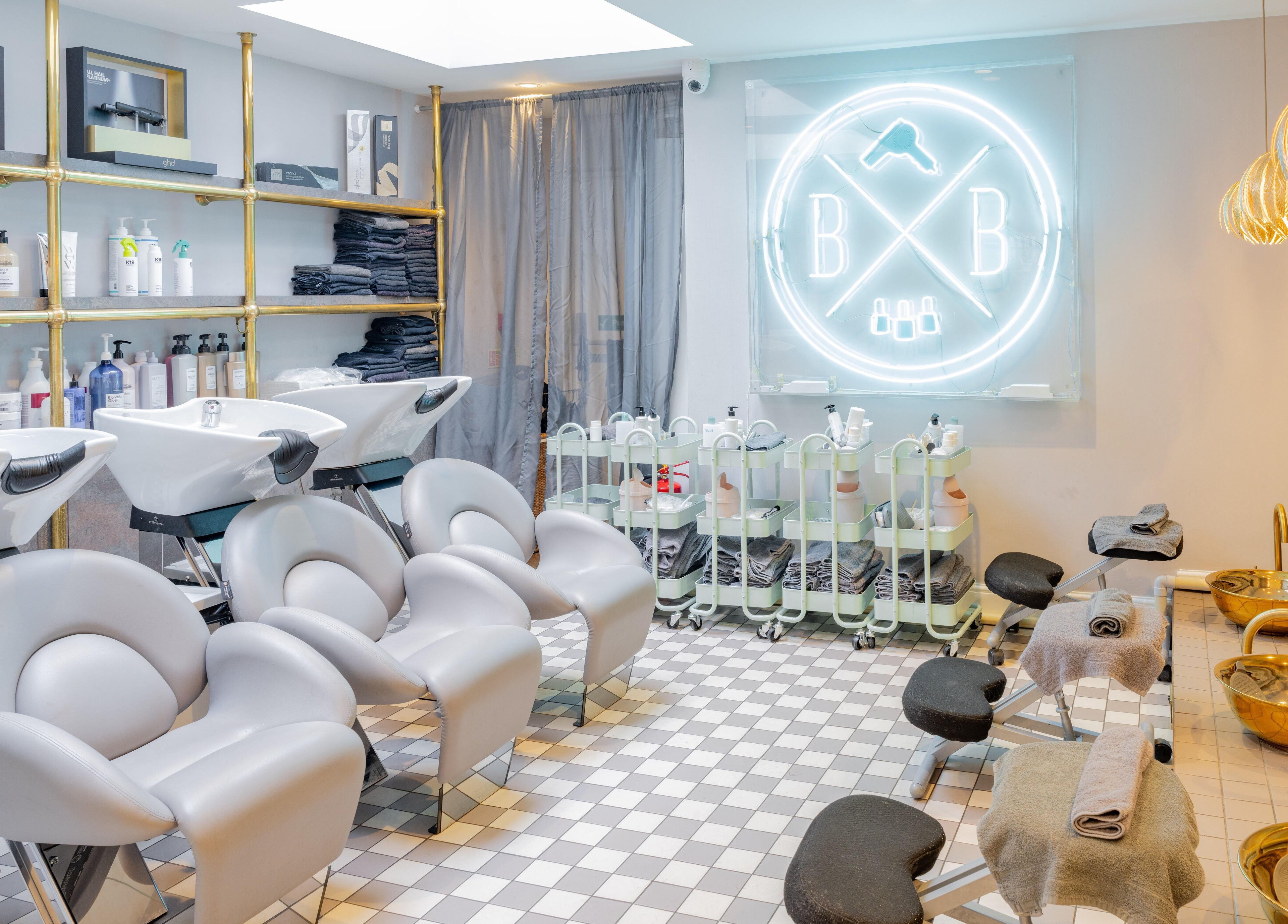 Blush + Blow London salon's elegant interior in London, England, GB, featuring modern styling stations and chic decor.