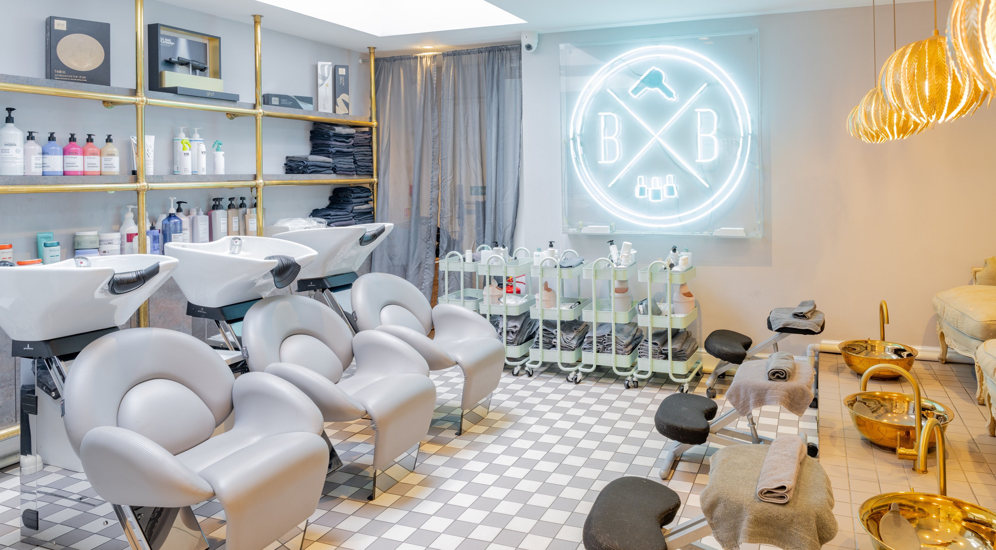 Blush + Blow London salon's elegant interior in London, England, GB, featuring modern styling stations and chic decor.