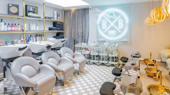 Blush + Blow London salon's elegant interior in London, England, GB, featuring modern styling stations and chic decor.