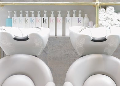 Modern wash stations at Blush + Blow London in London, England, GB, offering premium hair care products.