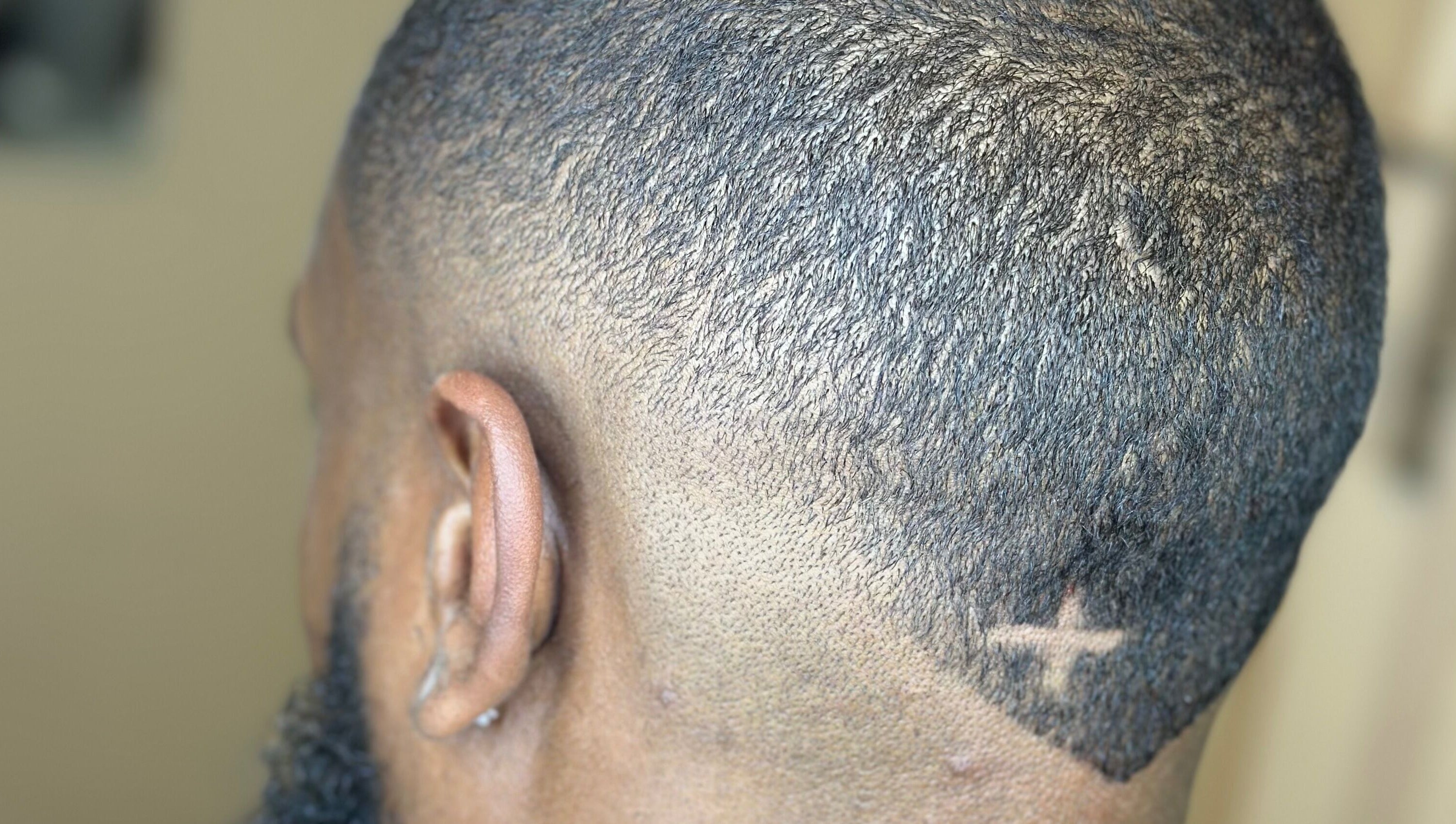 Close-up of a stylish fade haircut with a star design at AB Styles and Services, Dordrecht, Zuid-holland, NL.