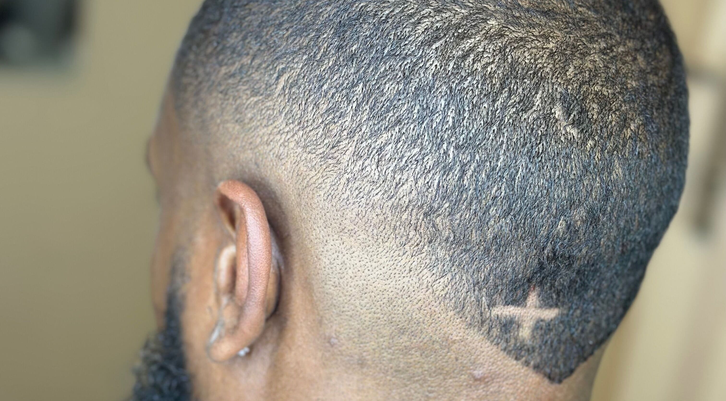 Close-up of a stylish fade haircut with a star design at AB Styles and Services, Dordrecht, Zuid-holland, NL.