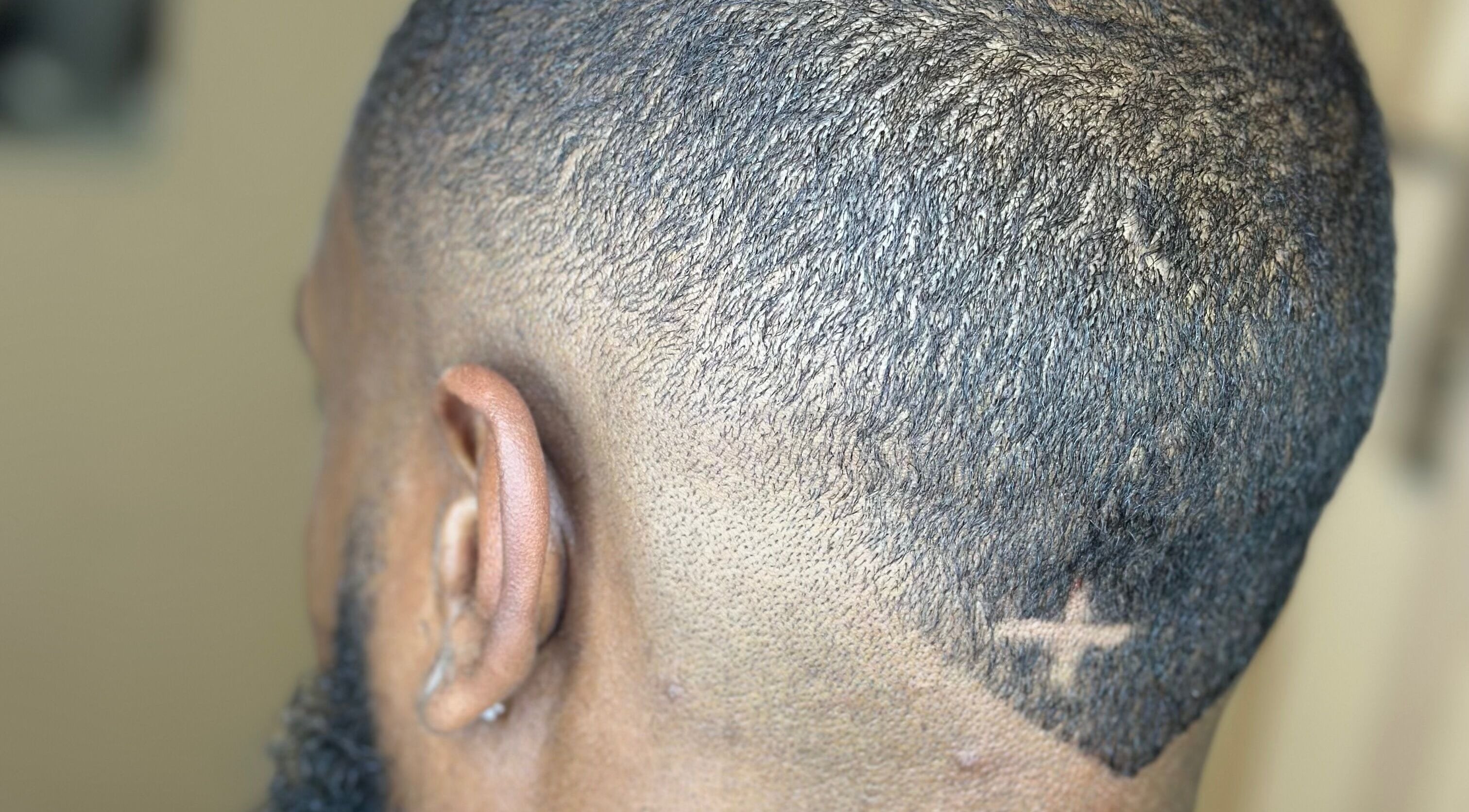 Close-up of a stylish fade haircut with a star design at AB Styles and Services, Dordrecht, Zuid-holland, NL.