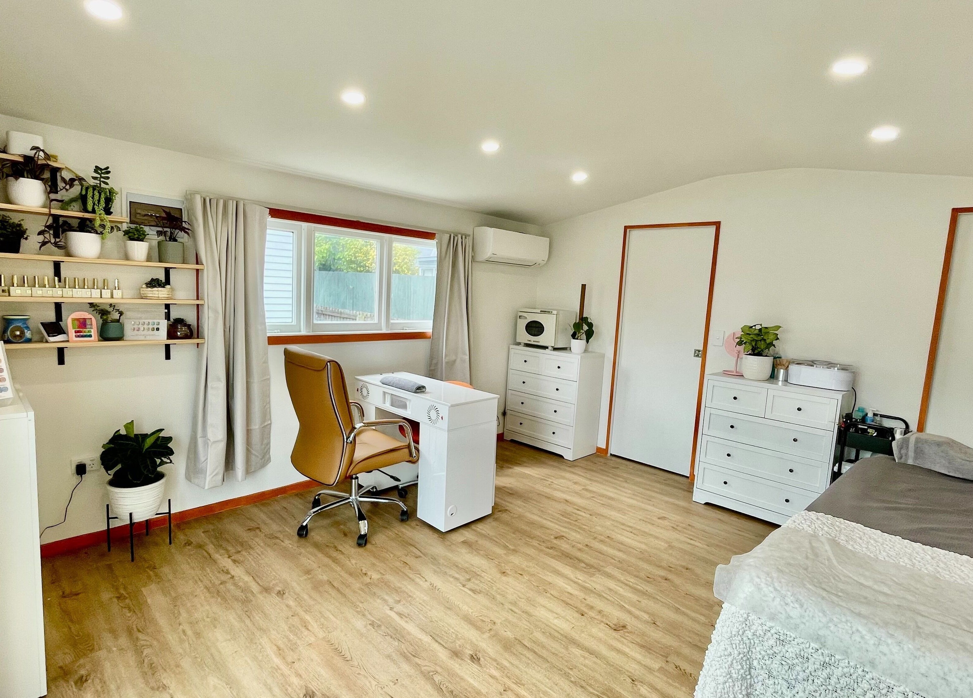 Modern, serene interior of Mercury Beauty Studio, Christchurch, Canterbury, NZ with cozy decor and plants.