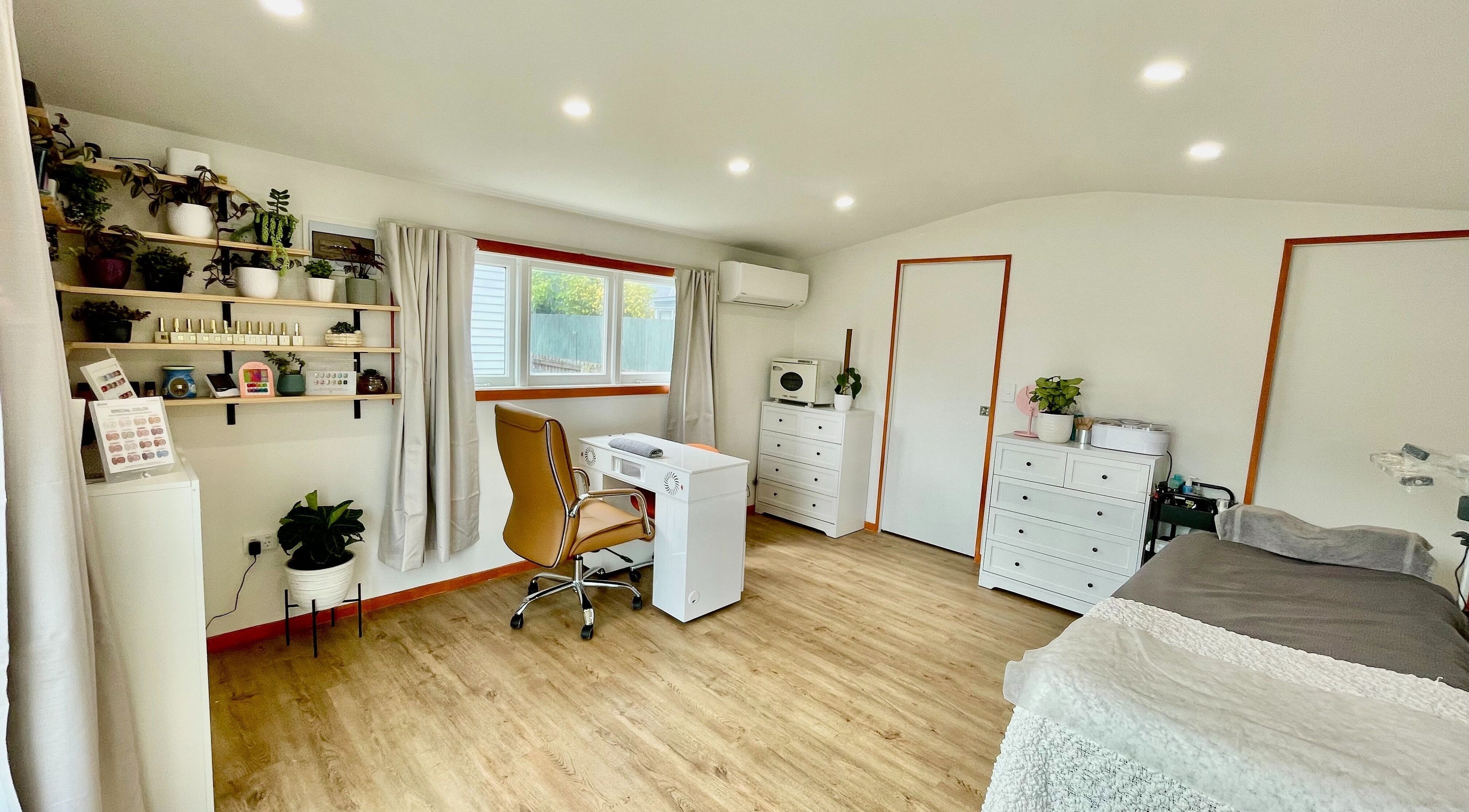 Modern, serene interior of Mercury Beauty Studio, Christchurch, Canterbury, NZ with cozy decor and plants.