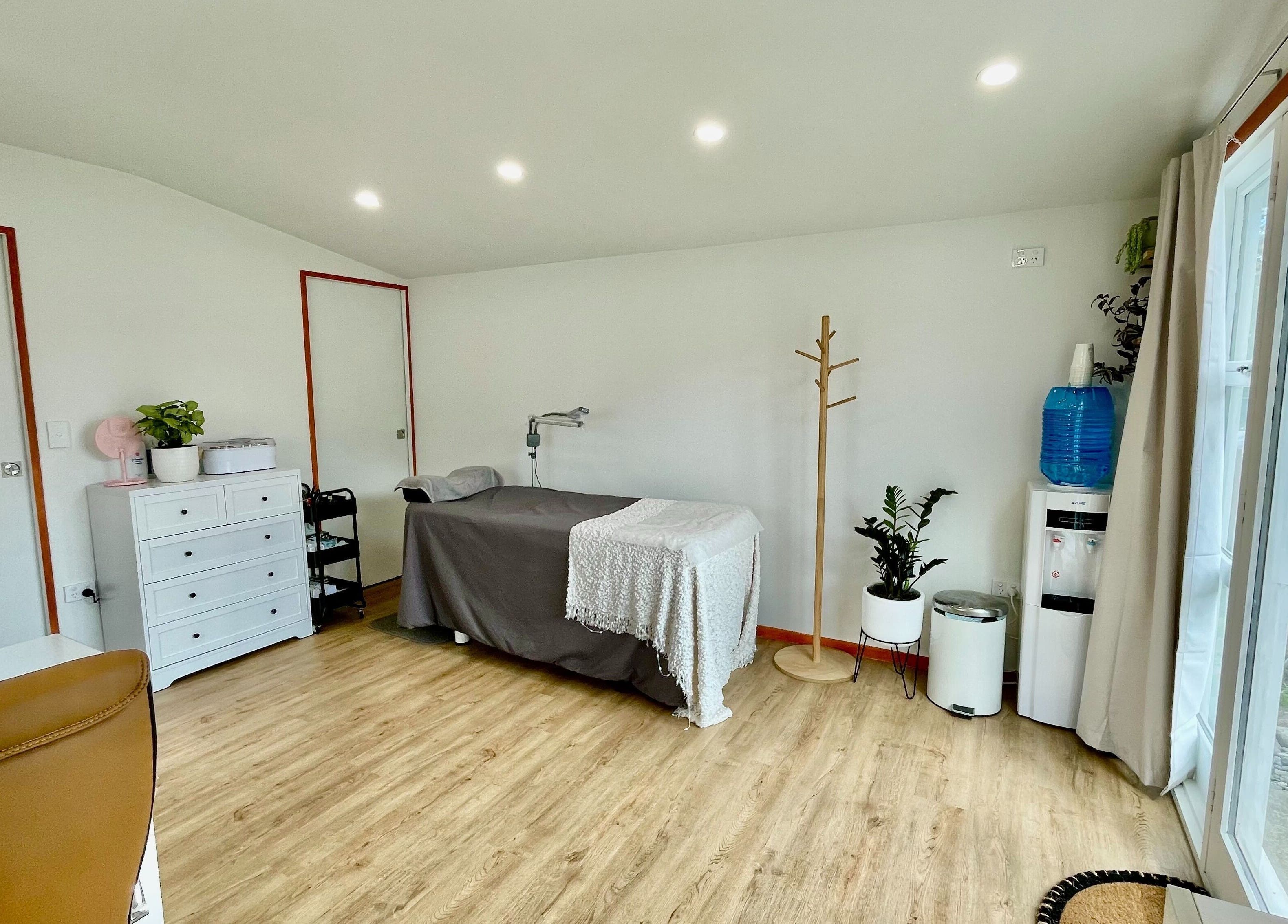 Relaxing treatment room at Mercury Beauty Studio, Christchurch, Canterbury, NZ with massage table.