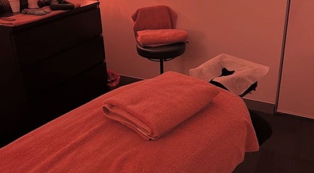 Serene massage room at Medicus Massage, Bondi Junction, New South Wales, AU, featuring neatly folded towels.