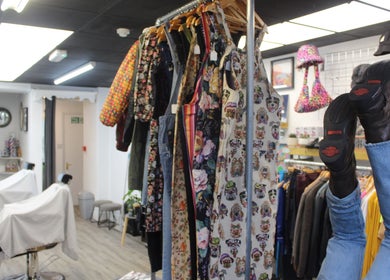 Inside Renegade: Cuts and Clobber, Douglas, vibrant clothing racks and unique decor create a stylish ambiance.