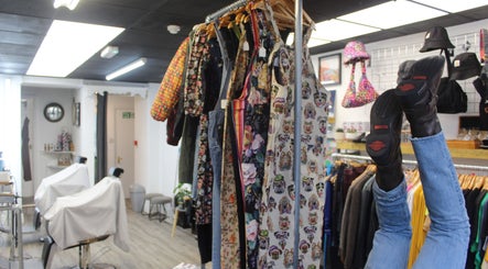 Inside Renegade: Cuts and Clobber, Douglas, vibrant clothing racks and unique decor create a stylish ambiance.