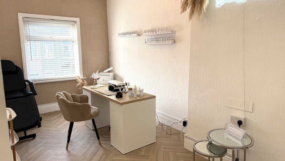 Elegant treatment room at Belleamie Beauty, Newport, Wales, GB with cozy decor and nail polish displays.
