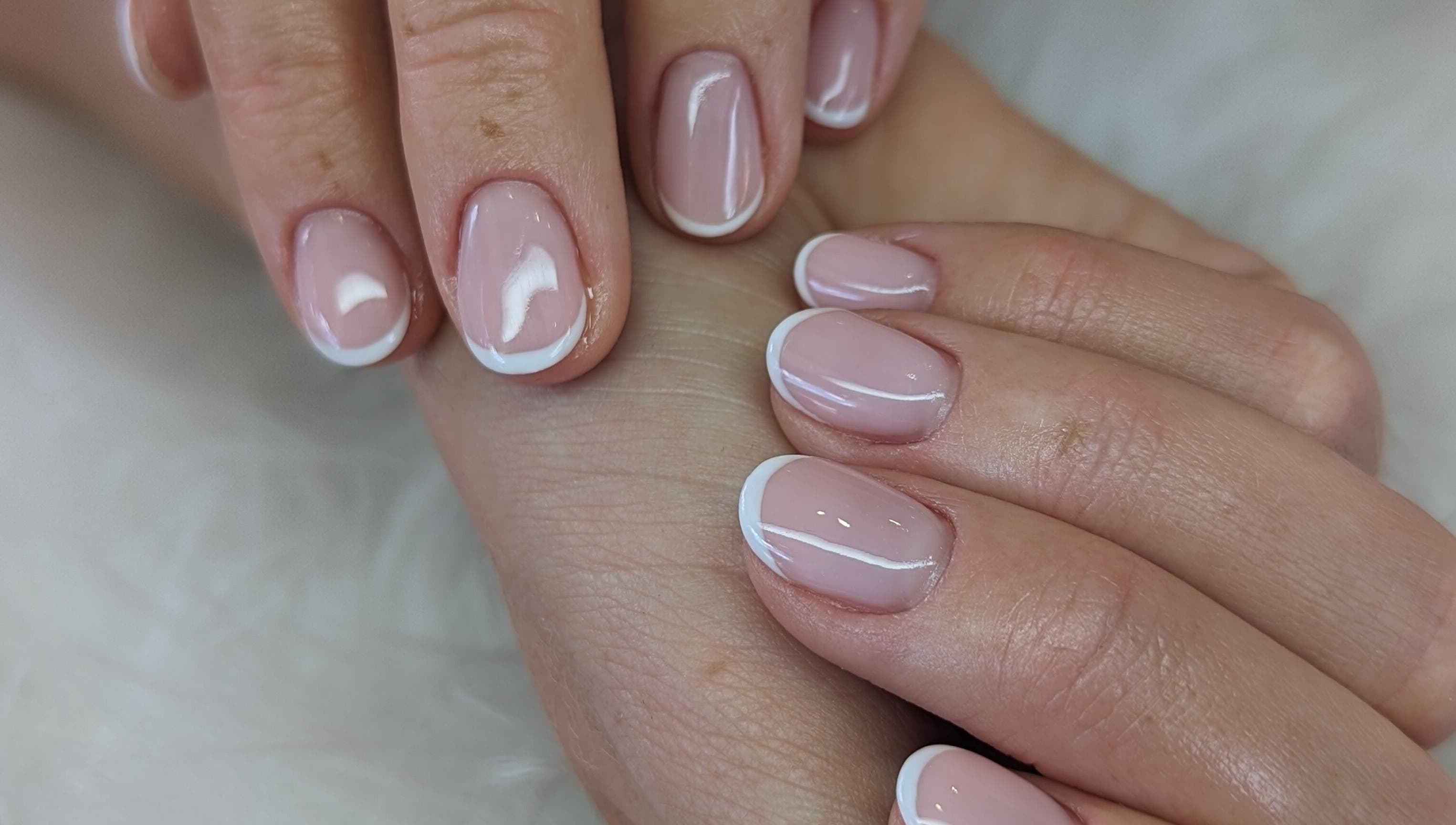 Elegant French manicure at Josie Leah’s Beauty in Montriond, Auvergne-rhône-alpes, FR. Perfectly polished nails.