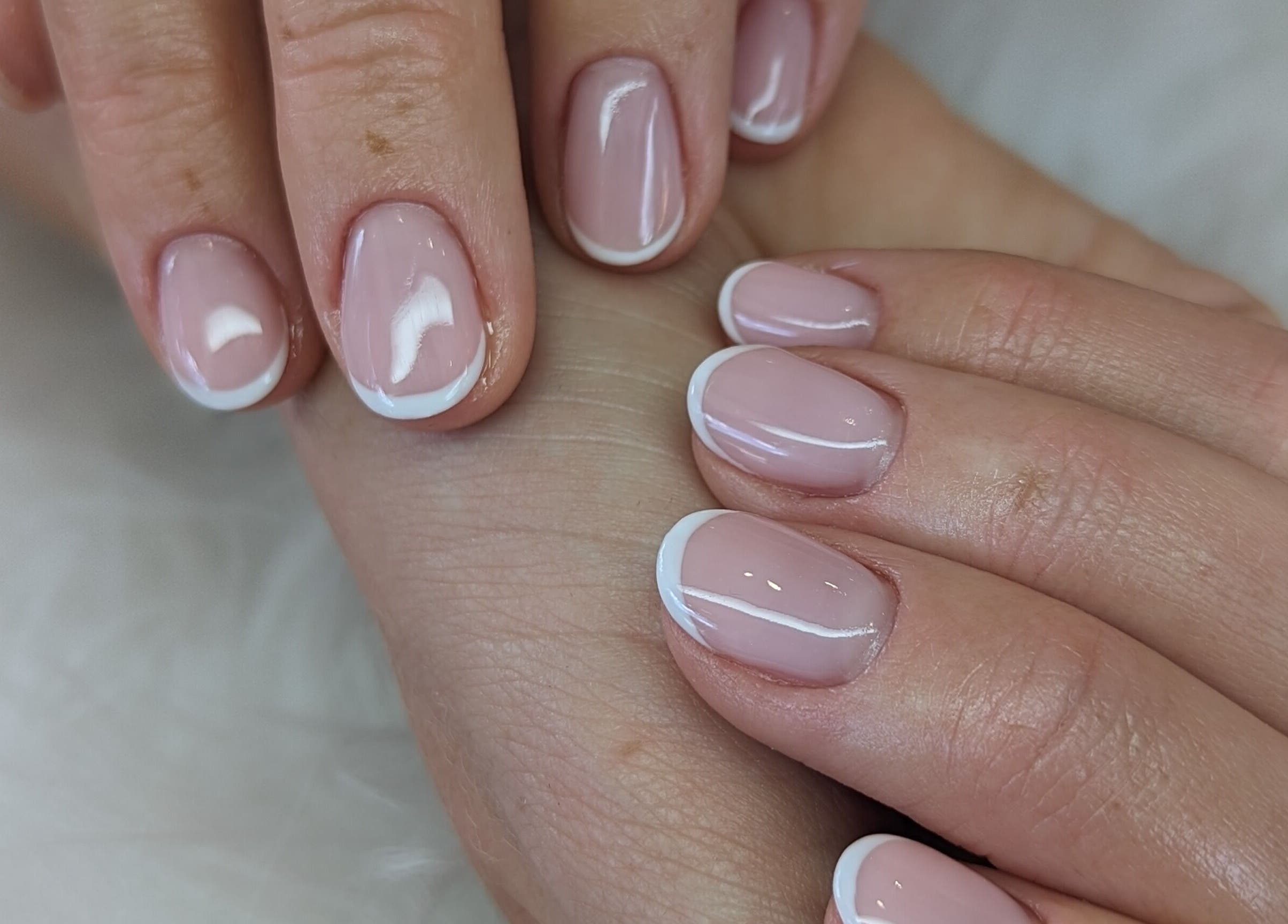 Elegant French manicure at Josie Leah’s Beauty in Montriond, Auvergne-rhône-alpes, FR. Perfectly polished nails.