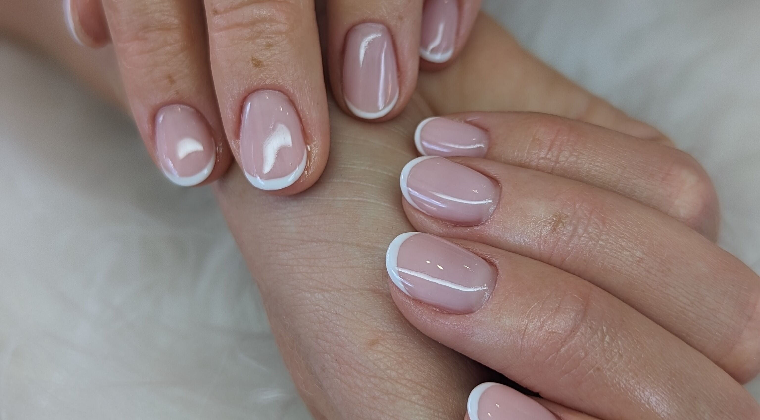 Elegant French manicure at Josie Leah’s Beauty in Montriond, Auvergne-rhône-alpes, FR. Perfectly polished nails.
