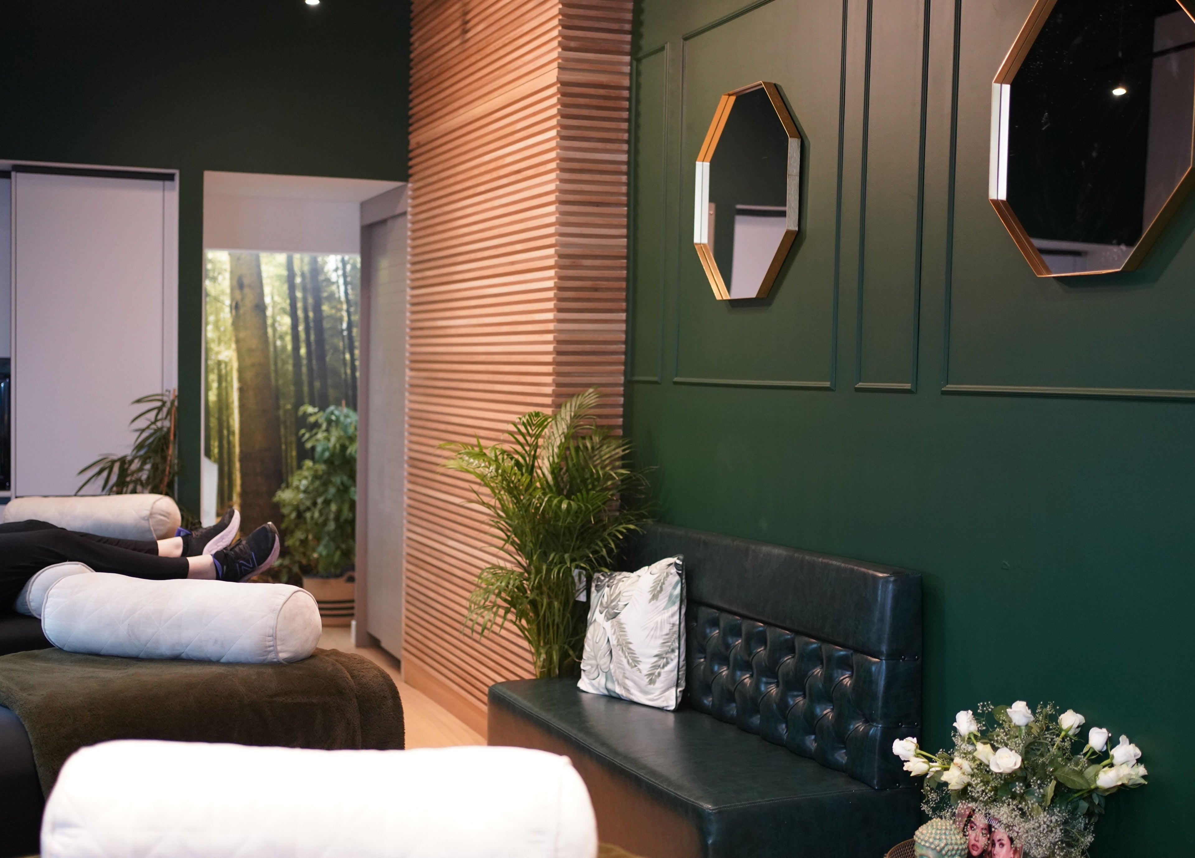 Relaxing interior of London Lash Lounge Ealing in London, England, GB with green walls and cozy seating.