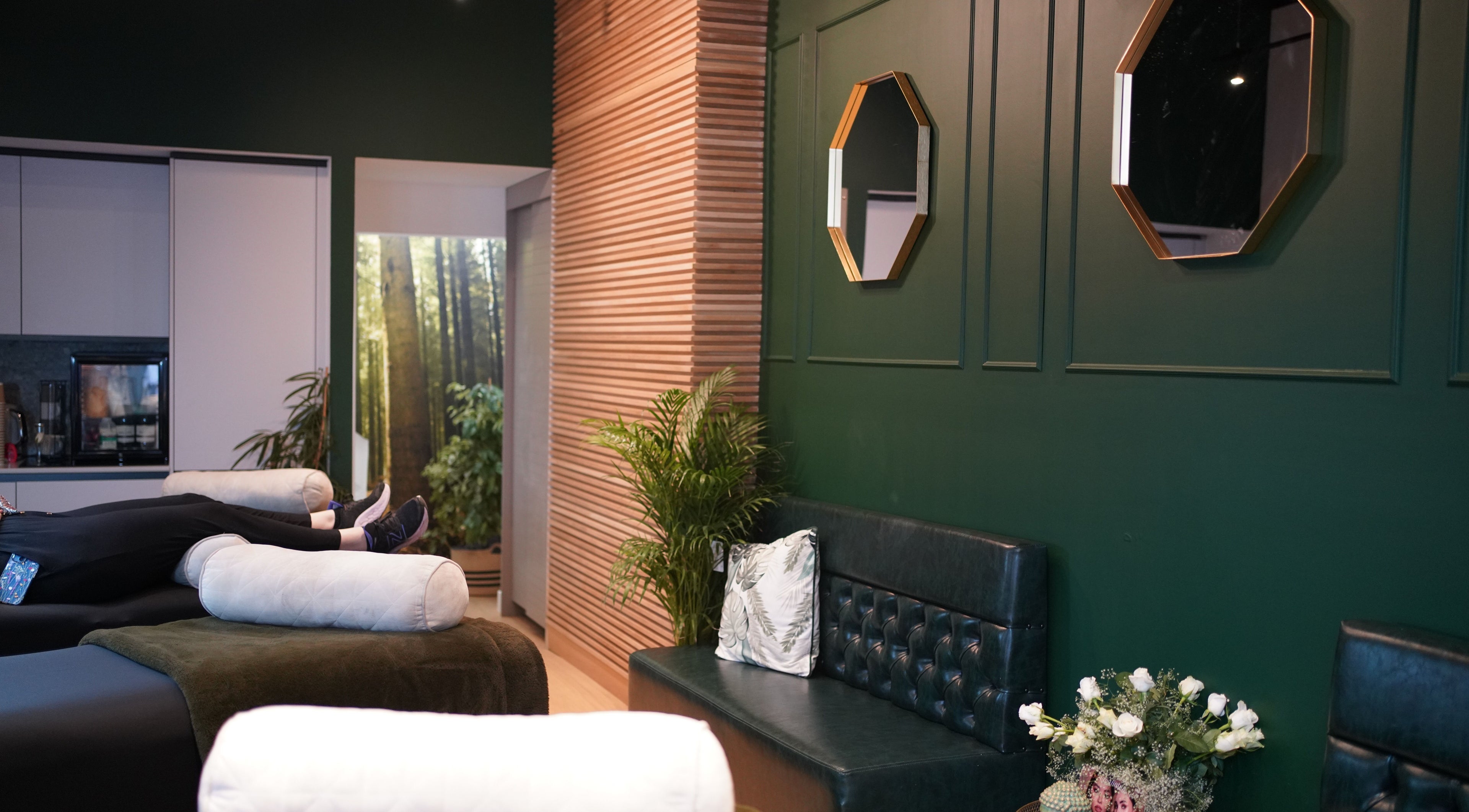 Relaxing interior of London Lash Lounge Ealing in London, England, GB with green walls and cozy seating.