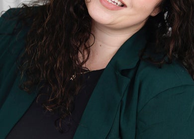 Smiling person at Body By Raquel in Tempe, Arizona, US, showcasing welcoming attire.