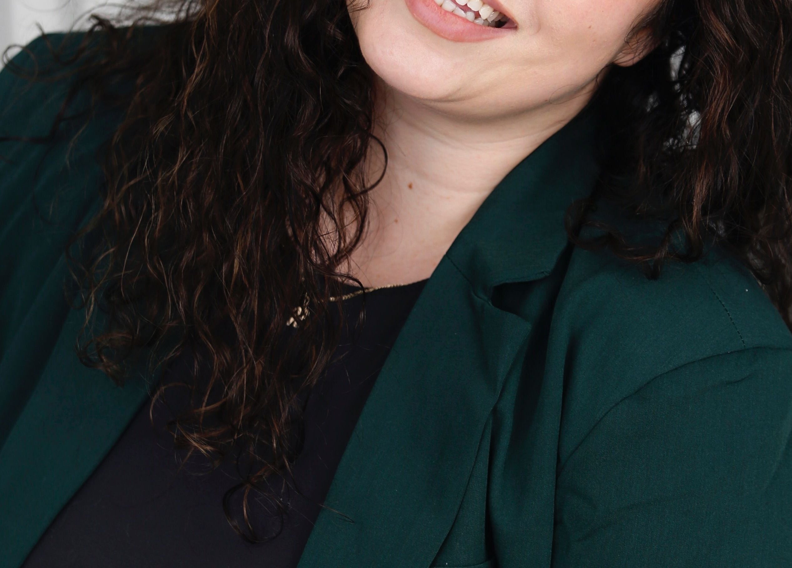 Smiling person at Body By Raquel in Tempe, Arizona, US, showcasing welcoming attire.