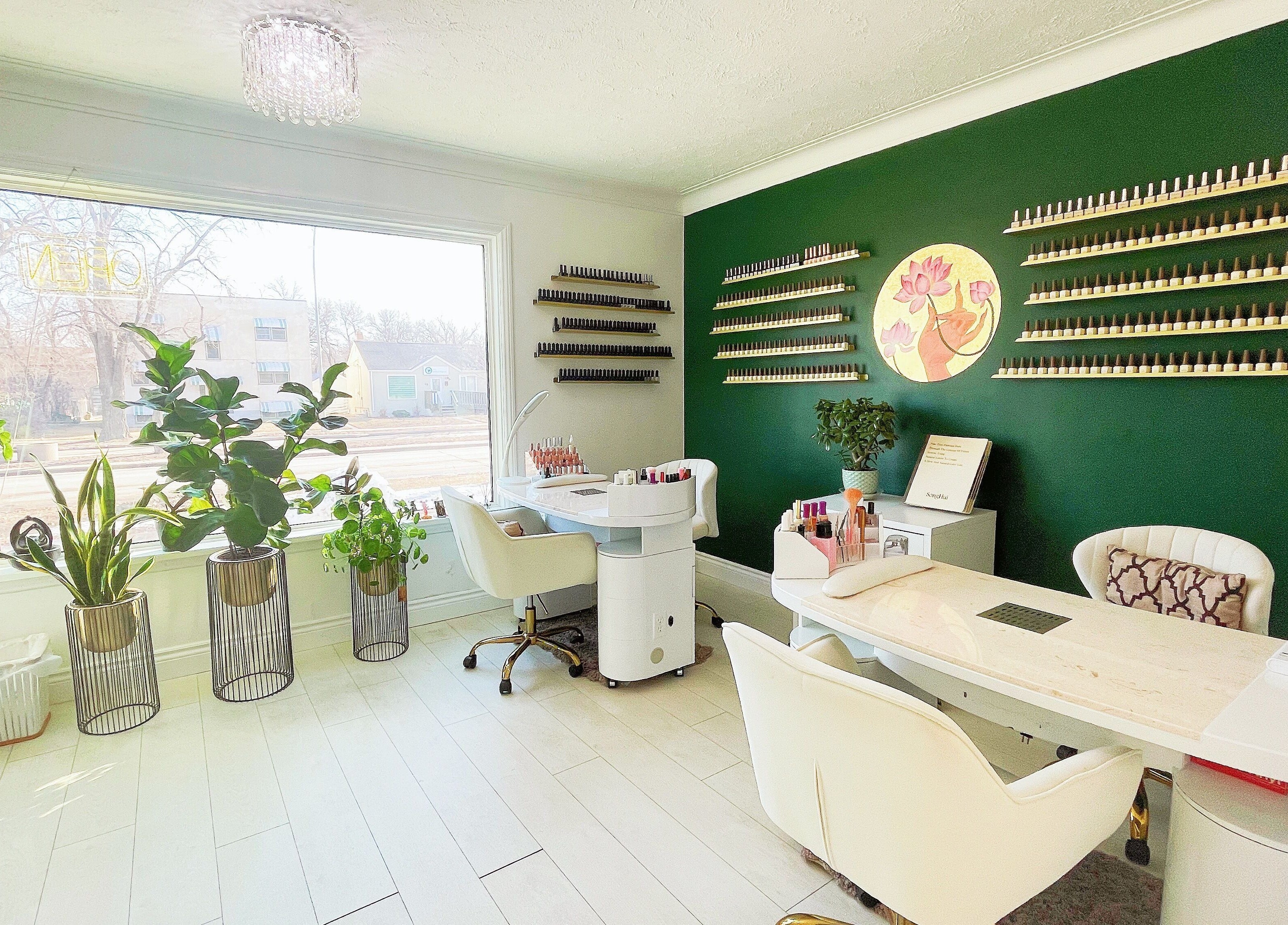 Elegant nail salon interior at SPA OJAS in Winnipeg, Manitoba, CA with lush plants and stylish décor.