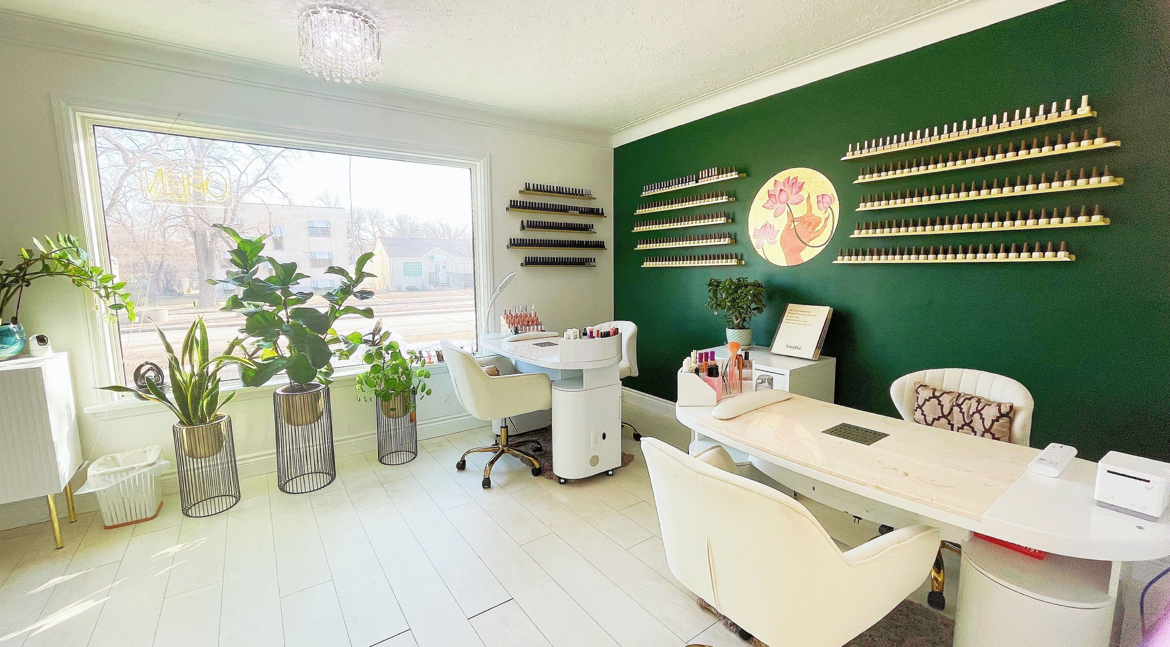 Elegant nail salon interior at SPA OJAS in Winnipeg, Manitoba, CA with lush plants and stylish décor.