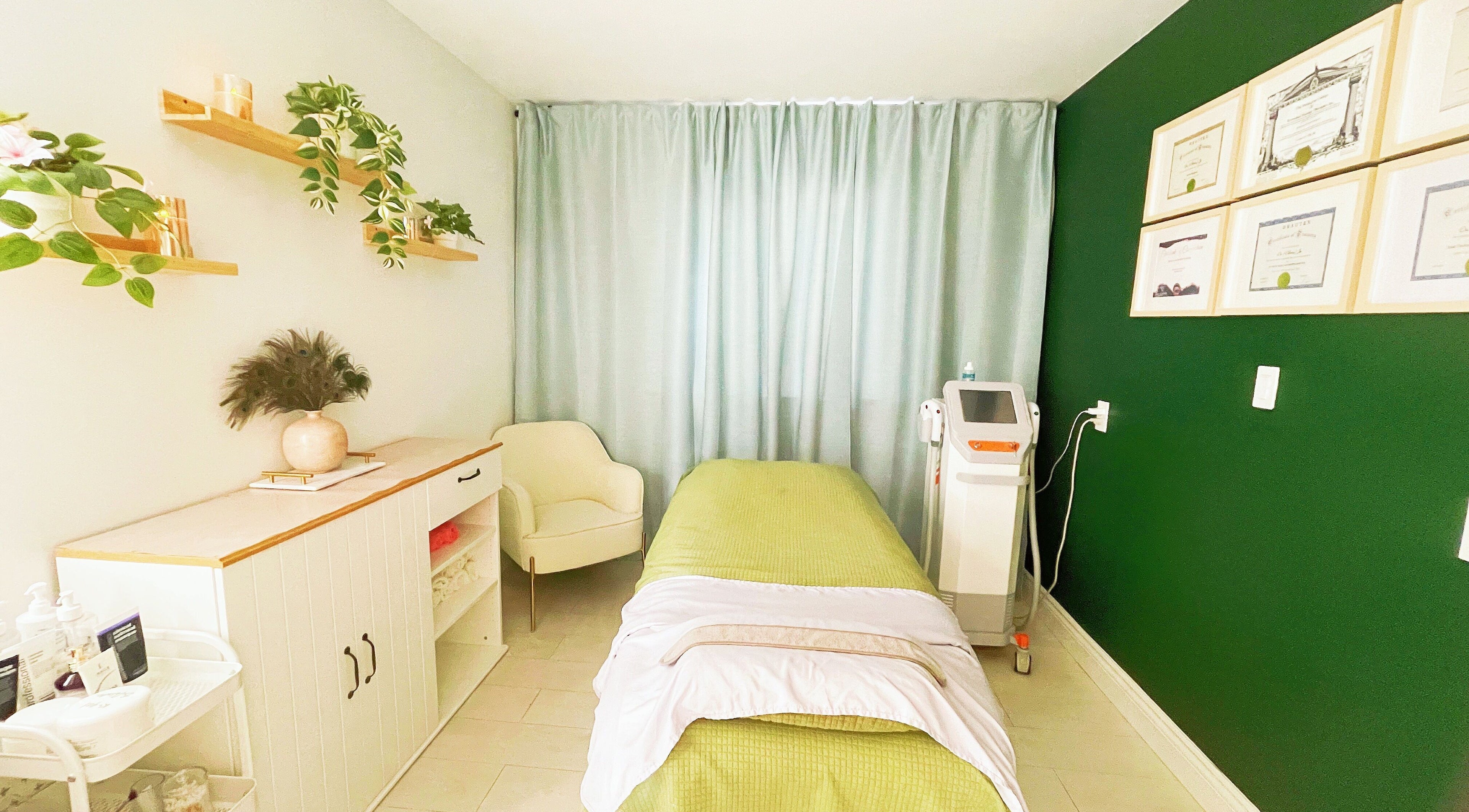 Relaxing treatment room at SPA OJAS, Winnipeg, Manitoba, CA, with cozy decor and green accents.