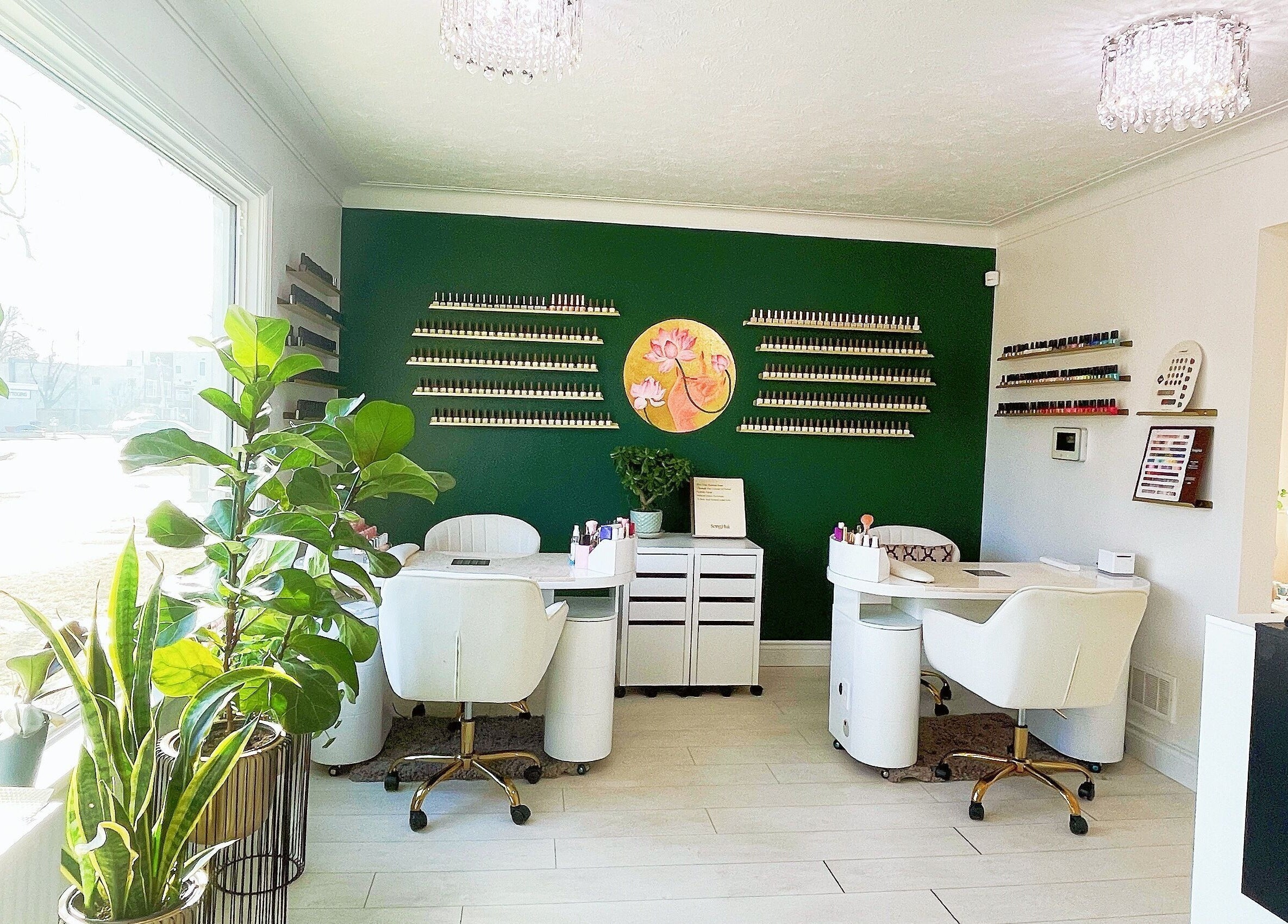 Stylish nail salon at SPA OJAS in Winnipeg, Manitoba, CA with green walls and elegant seating.