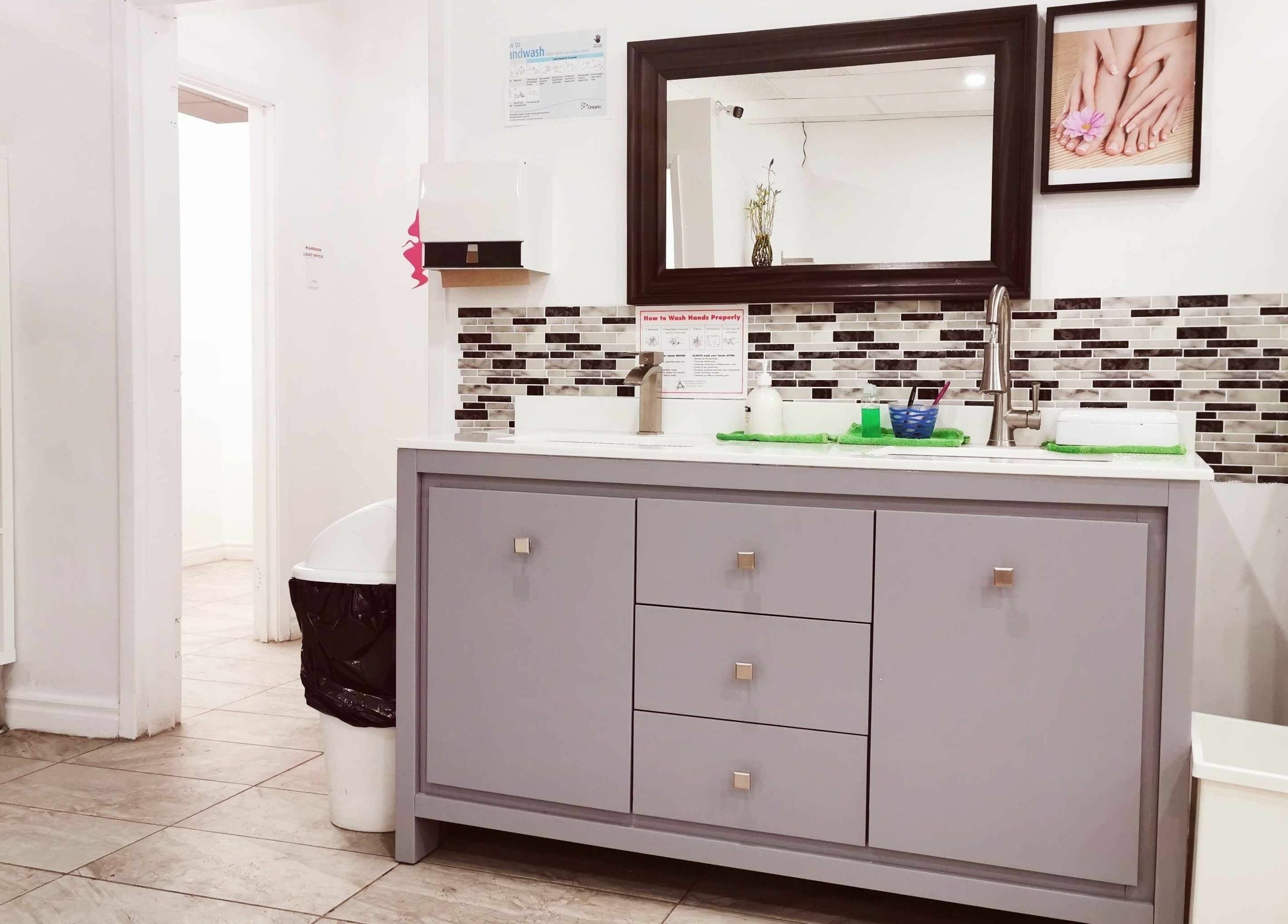 Spacious vanity area at Fancy Nails & Spa, Cobourg, Ontario, CA with modern decor and hand-washing station.
