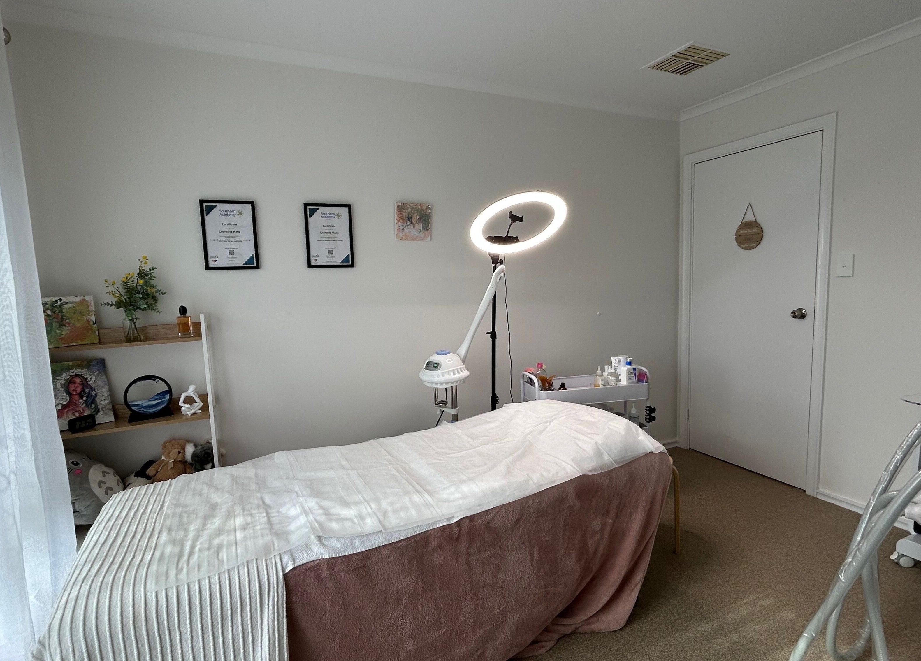 Calm treatment room at Bella Beauty Studio in Leeming, Western Australia, AU, featuring cozy bed and soft lighting.