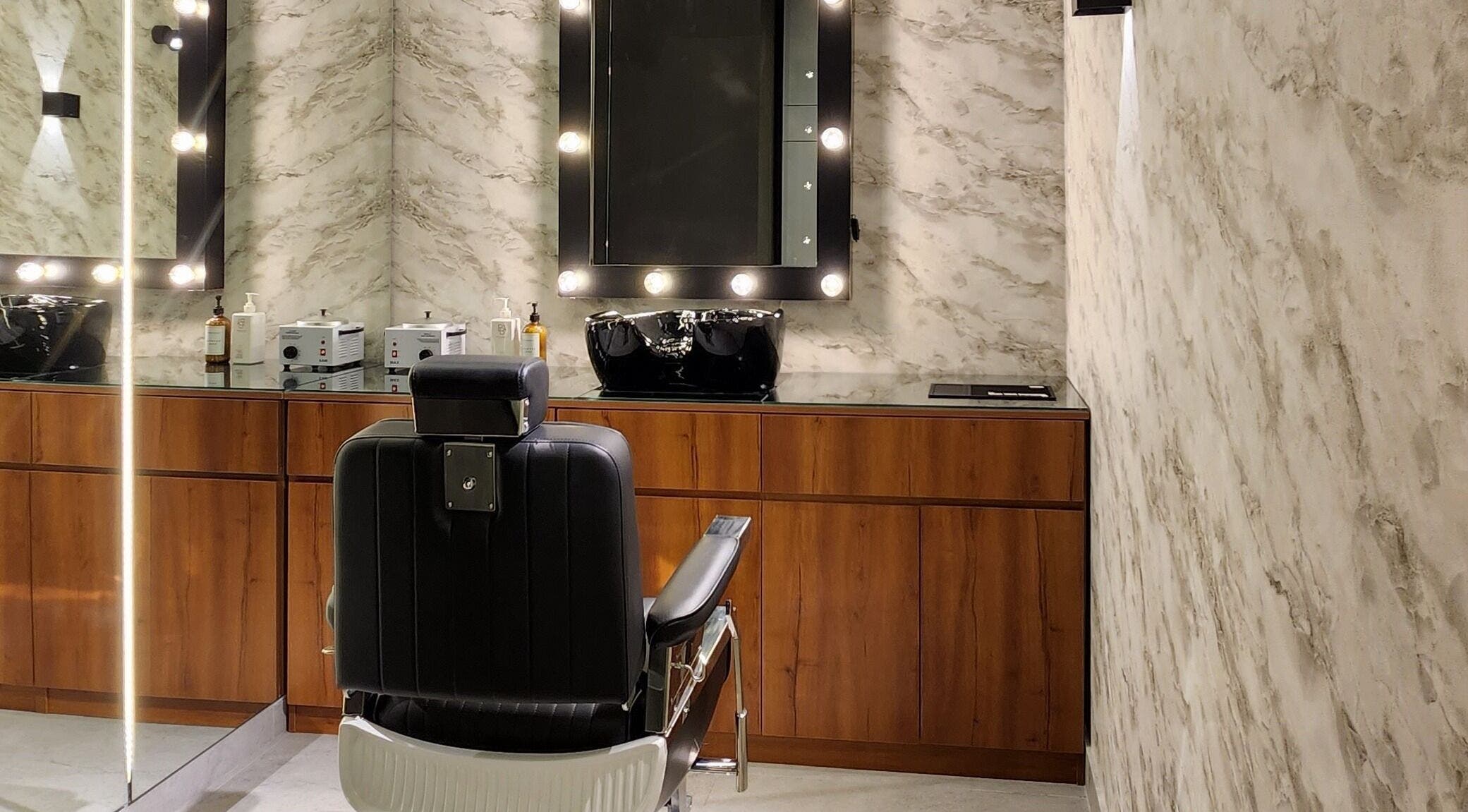 Sophisticated barber chair at Backyard Barbers, أبو ظبي, أبو ظبي, AE, featuring elegant wooden decor.