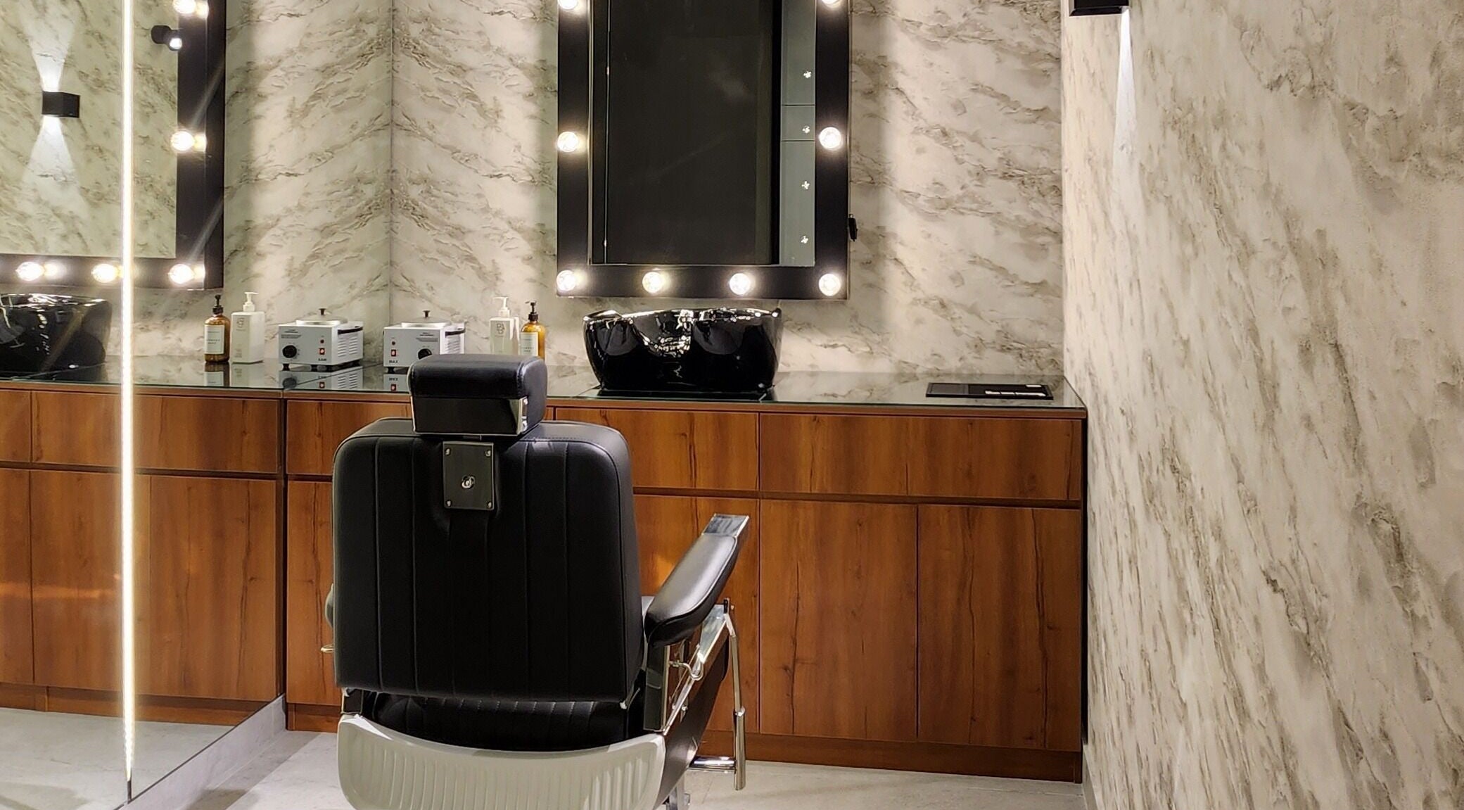 Sophisticated barber chair at Backyard Barbers, أبو ظبي, أبو ظبي, AE, featuring elegant wooden decor.