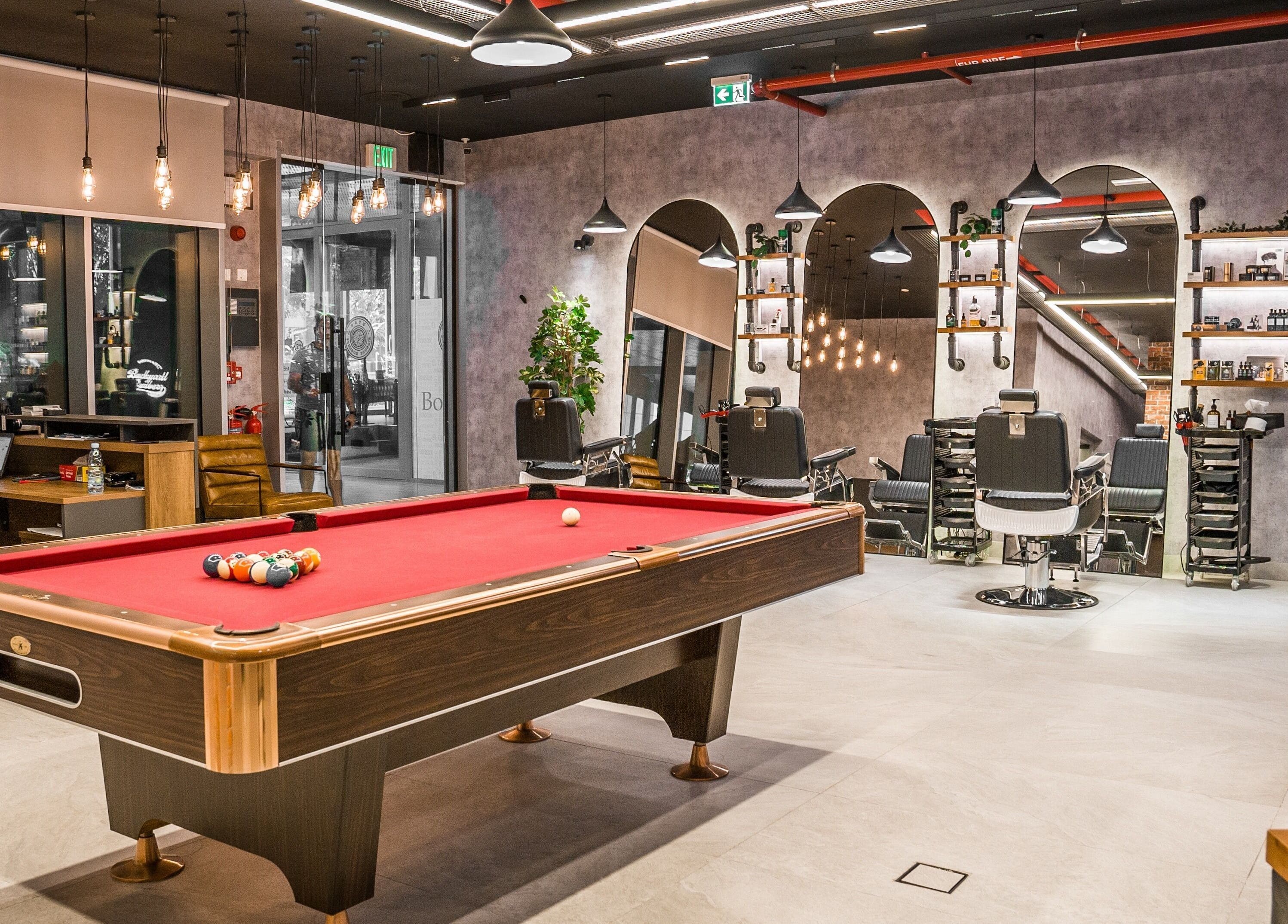 Luxurious interior of Backyard Barbers with pool table and barber chairs in Abu Dhabi, أبو ظبي, AE.