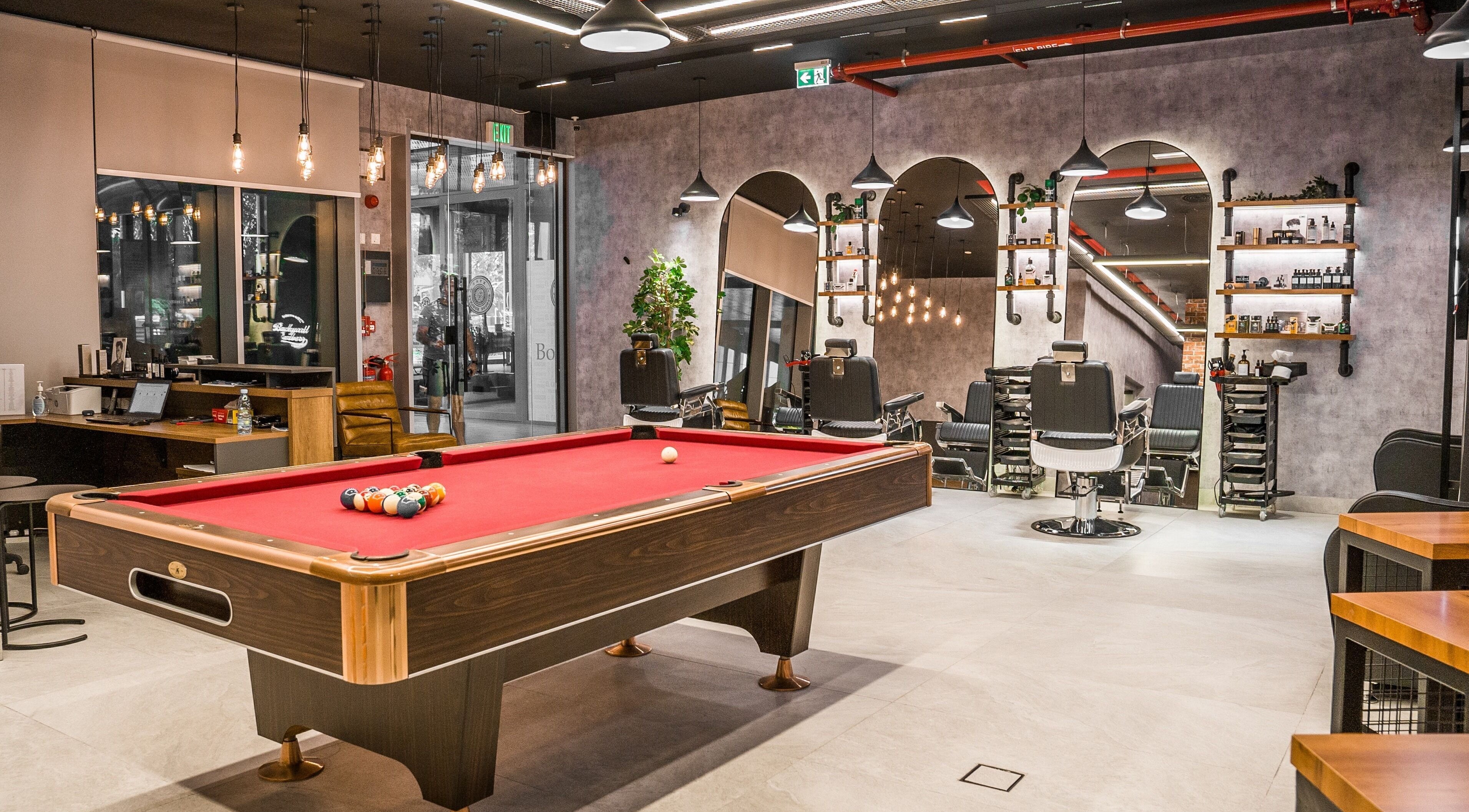 Luxurious interior of Backyard Barbers with pool table and barber chairs in Abu Dhabi, أبو ظبي, AE.