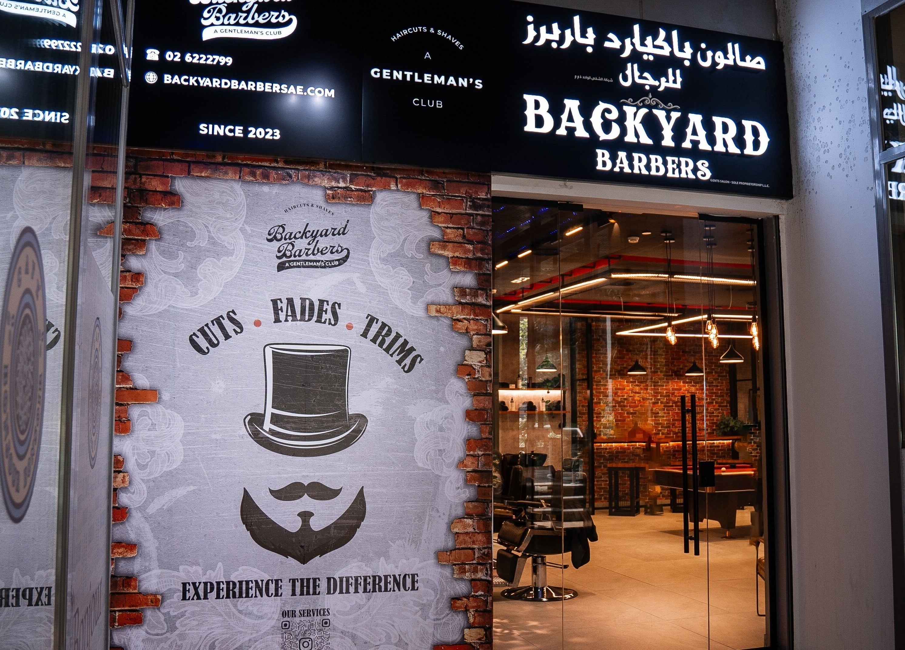 Entrance of Backyard Barbers in Abu Dhabi, featuring stylish decor inviting visitors for cuts, fades, and trims.