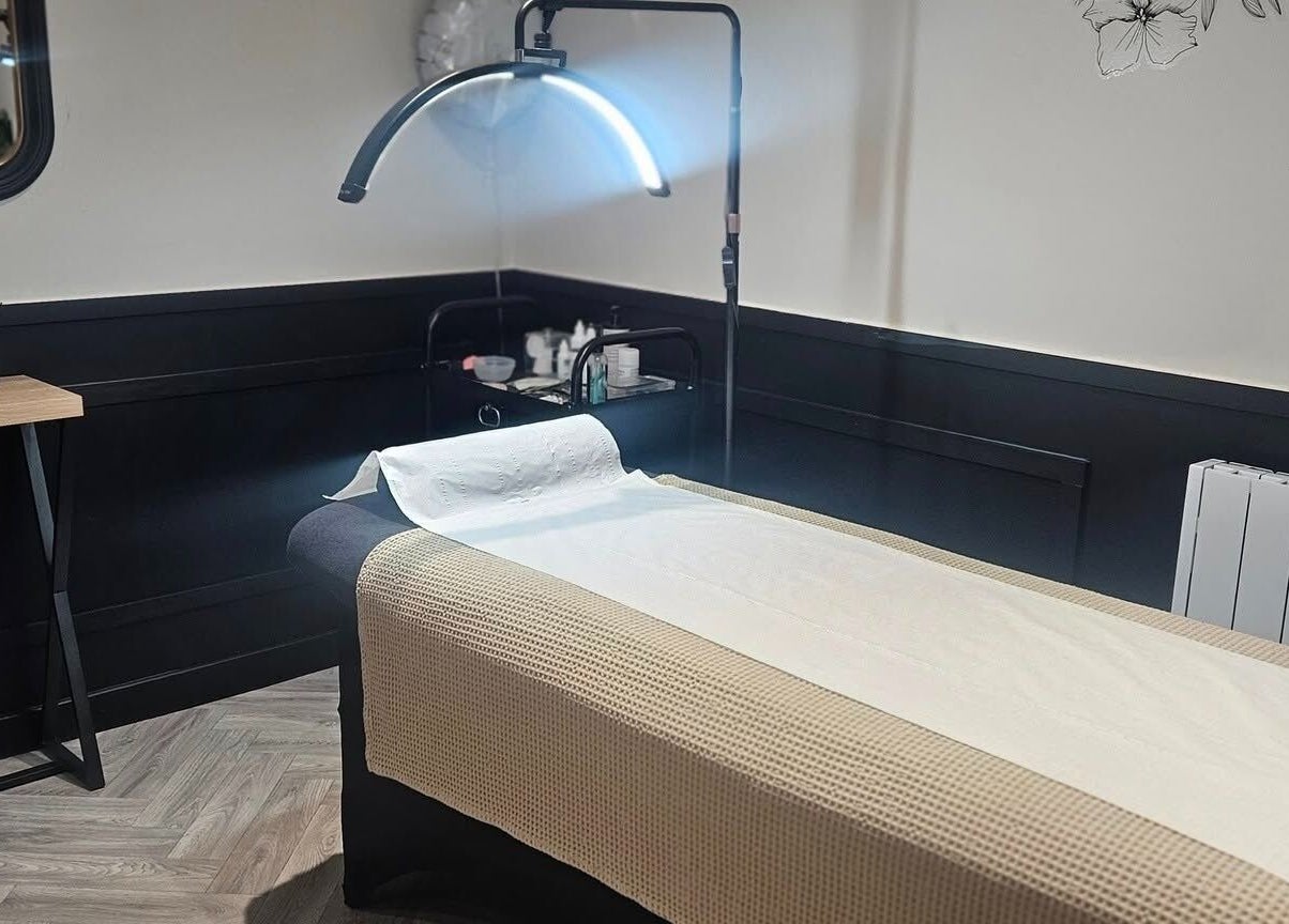 Cozy treatment room at Scarra Beauty in Oban, Scotland, GB, featuring a well-prepared massage table.