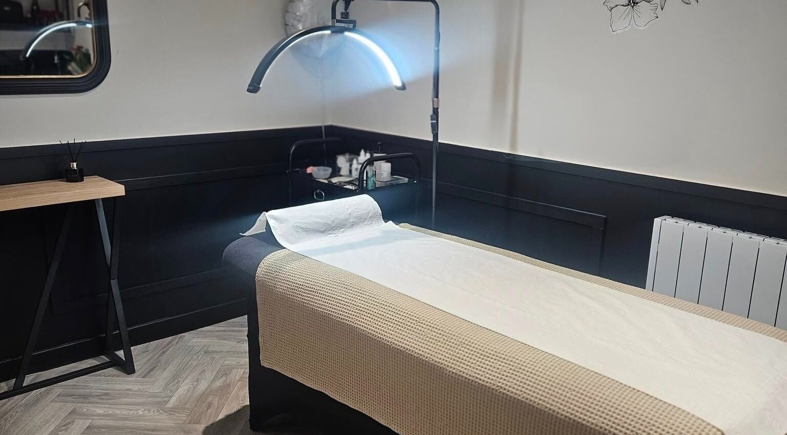 Cozy treatment room at Scarra Beauty in Oban, Scotland, GB, featuring a well-prepared massage table.