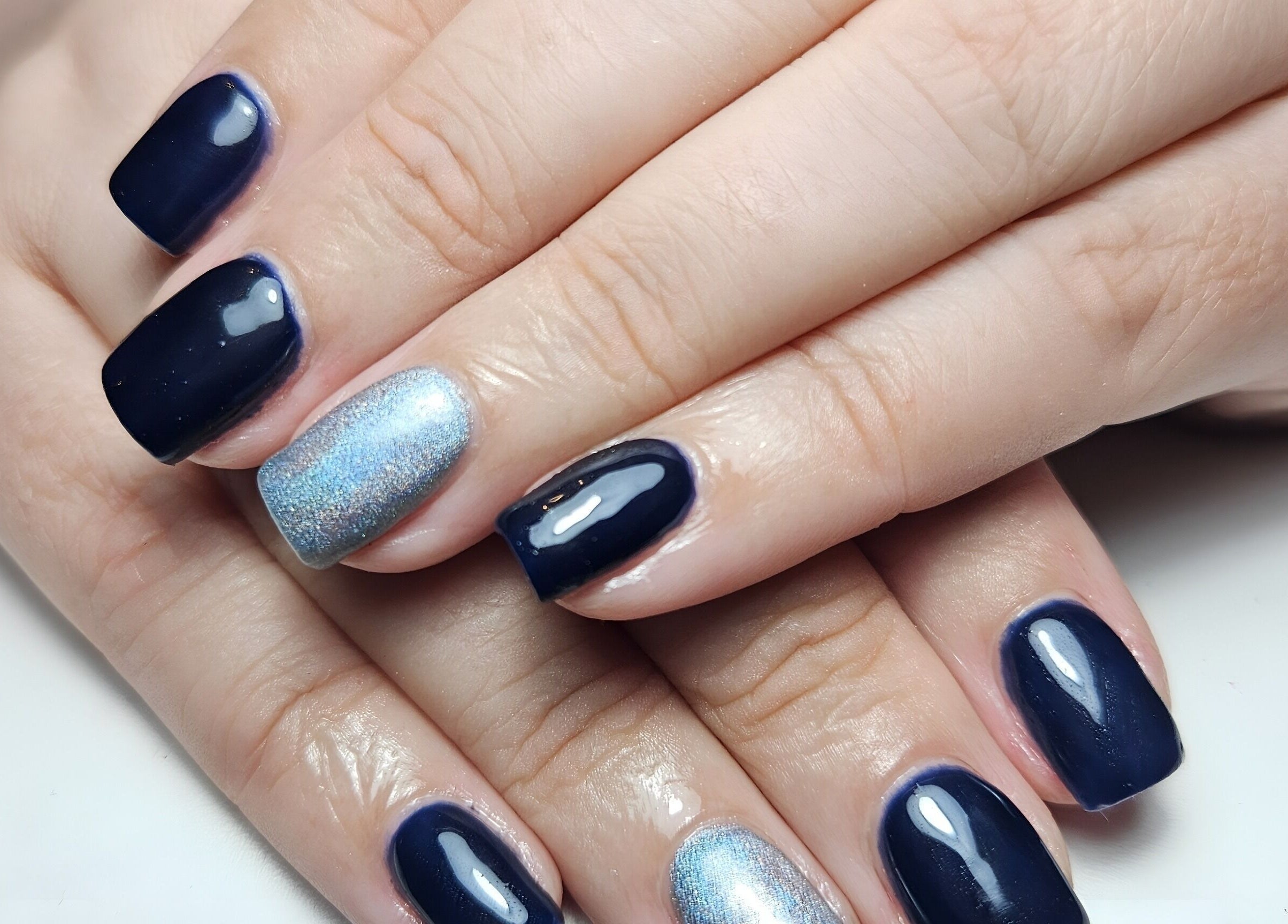Navy and silver nails at Scarra Beauty, Oban, Scotland, GB offer a chic, polished look in a stunning design.