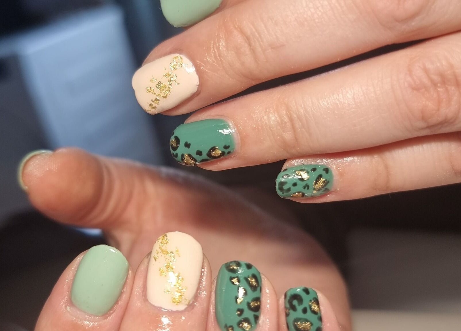 Elegant nail art with green and gold accents at Scarra Beauty, Oban, Scotland, GB.