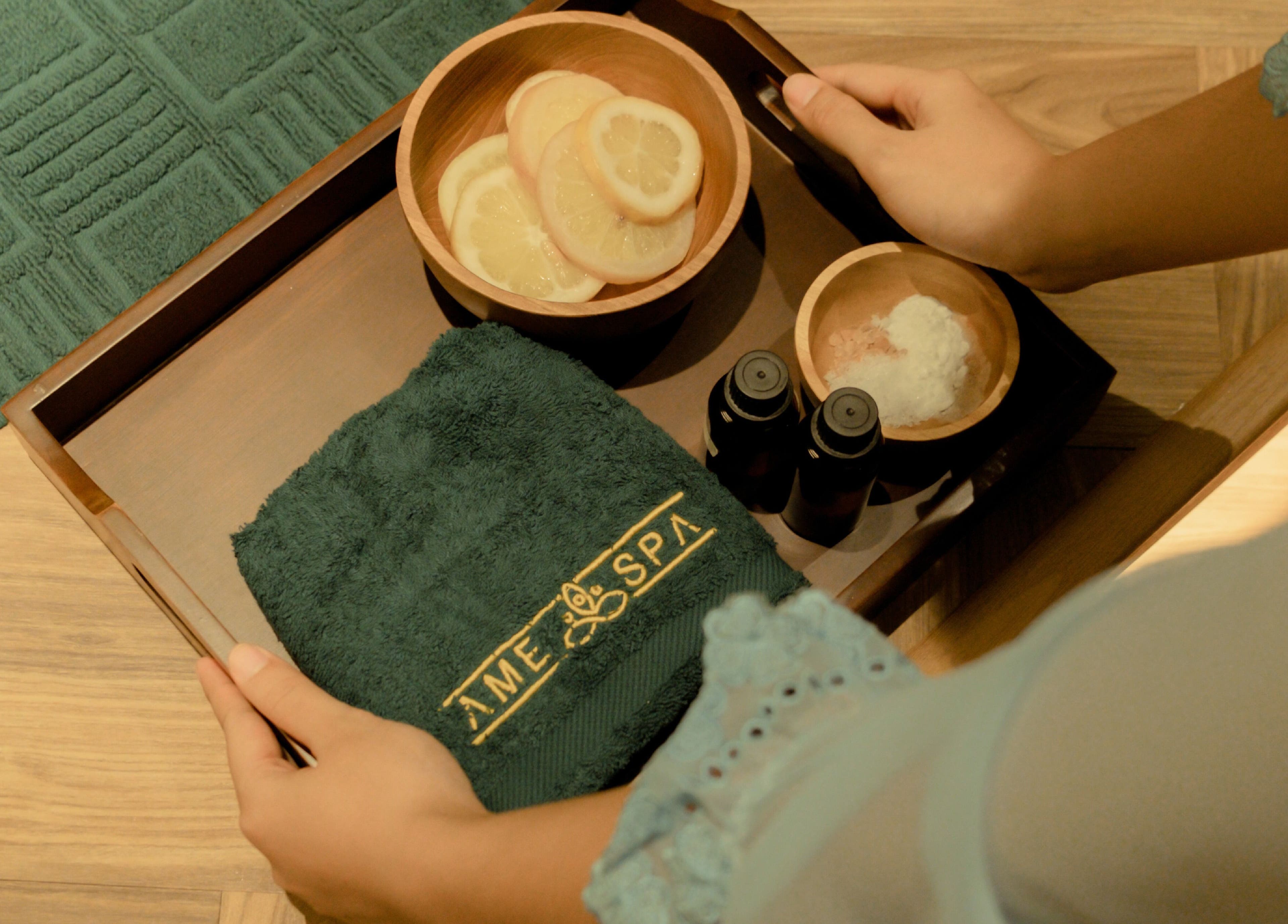Spa essentials tray at Ame Spa Thamrin, Daerah Khusus Ibukota Jakarta, ID, featuring towel and oils.