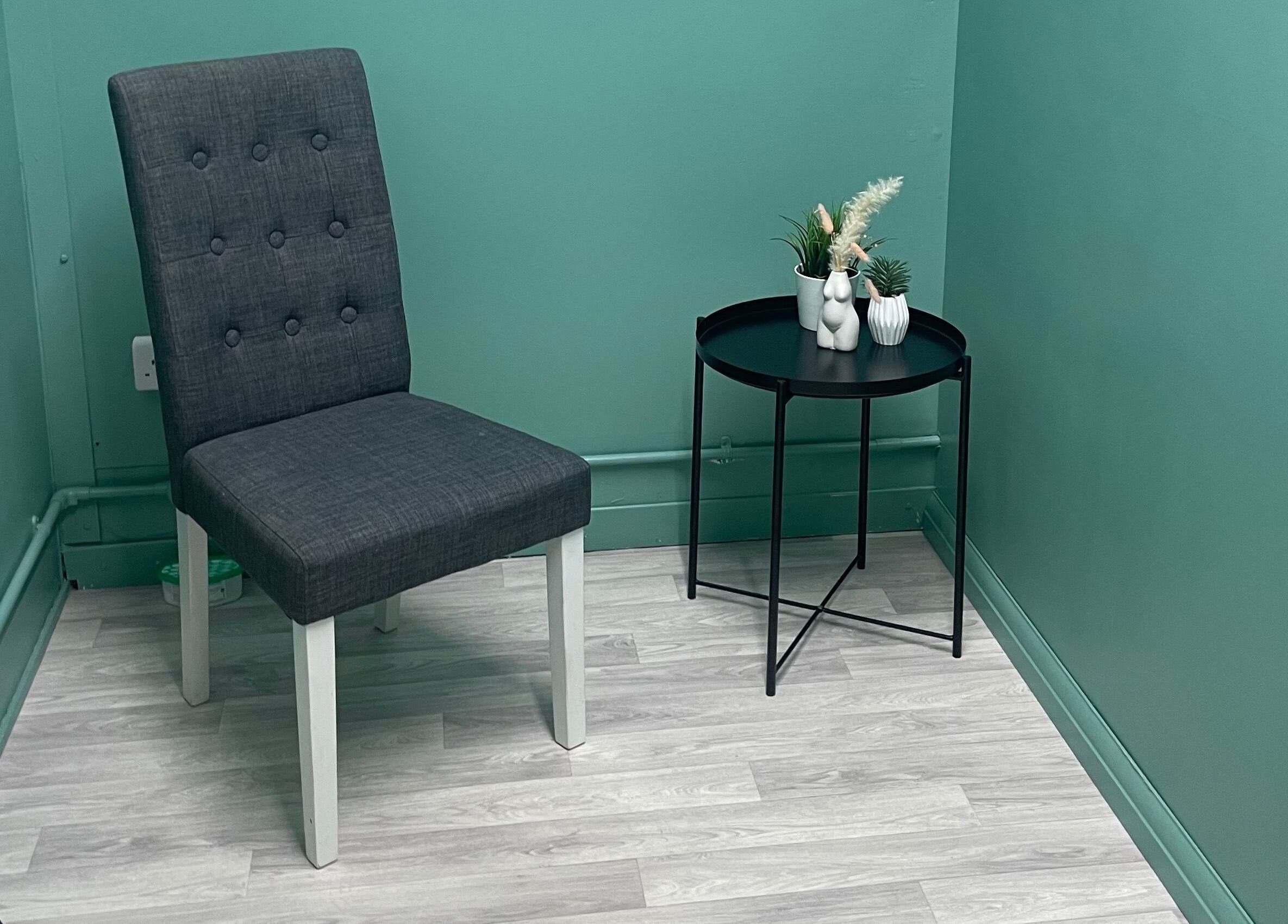 Relaxing corner with chair and table at Wax with Hazel - Intimate Wax Specialist, Wellingborough, England, GB.