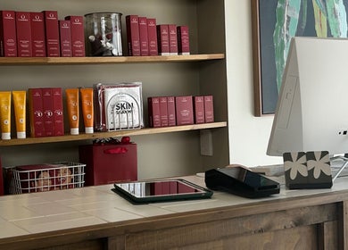 Reception desk and skincare products at Covet Beauty, Waratah, New South Wales, AU.