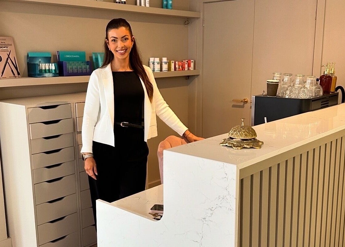 Welcoming receptionist at Blossom, Neath, Wales, GB, in a stylish modern interior.