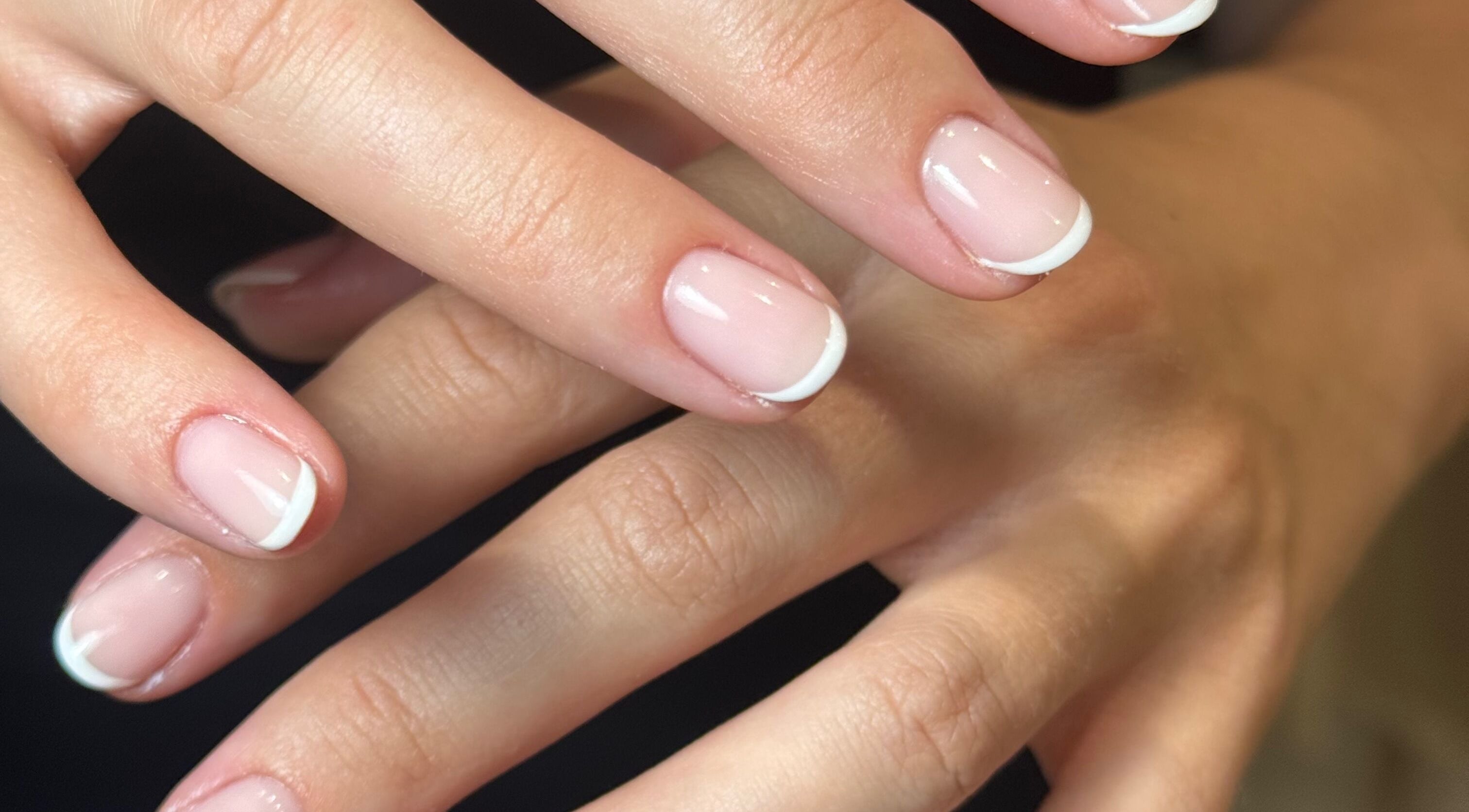 Elegant French manicure at By Olivia Jo, Ashton-under-lyne, England, GB showcasing exquisite nail art.