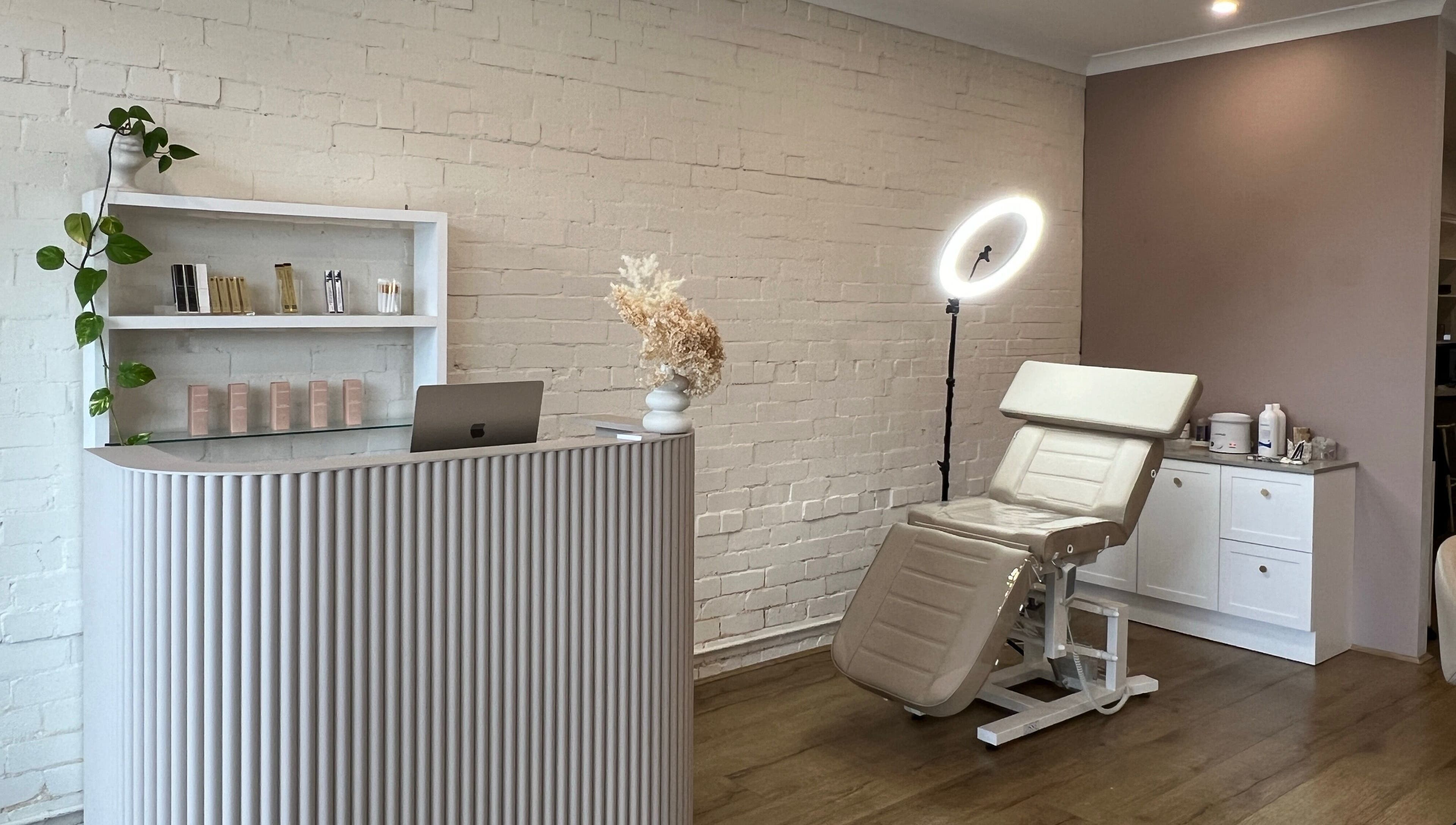 Ona Lash and Brow Bar in Melbourne, Victoria, AU features a modern reception and treatment chair with soft lighting.