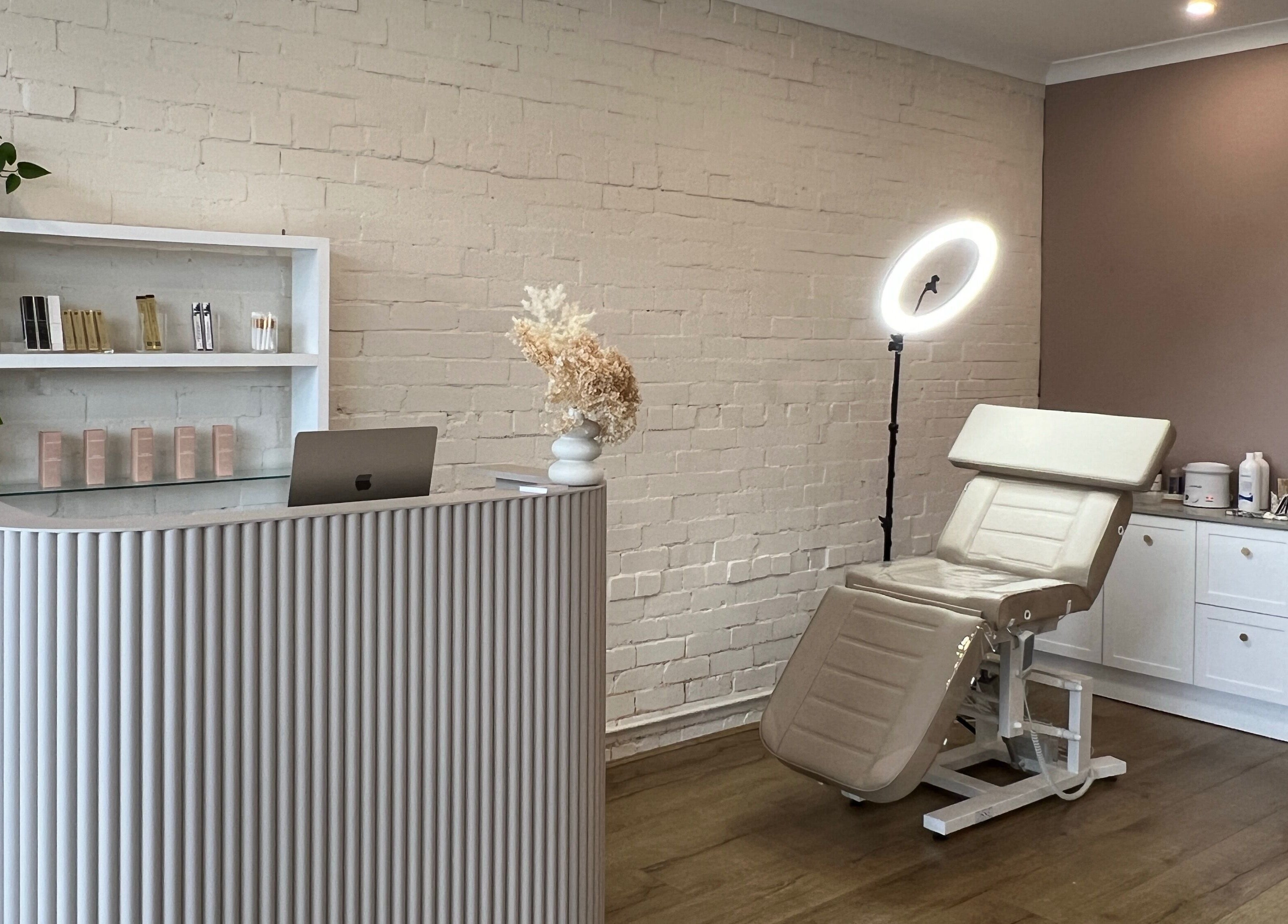 Ona Lash and Brow Bar in Melbourne, Victoria, AU features a modern reception and treatment chair with soft lighting.