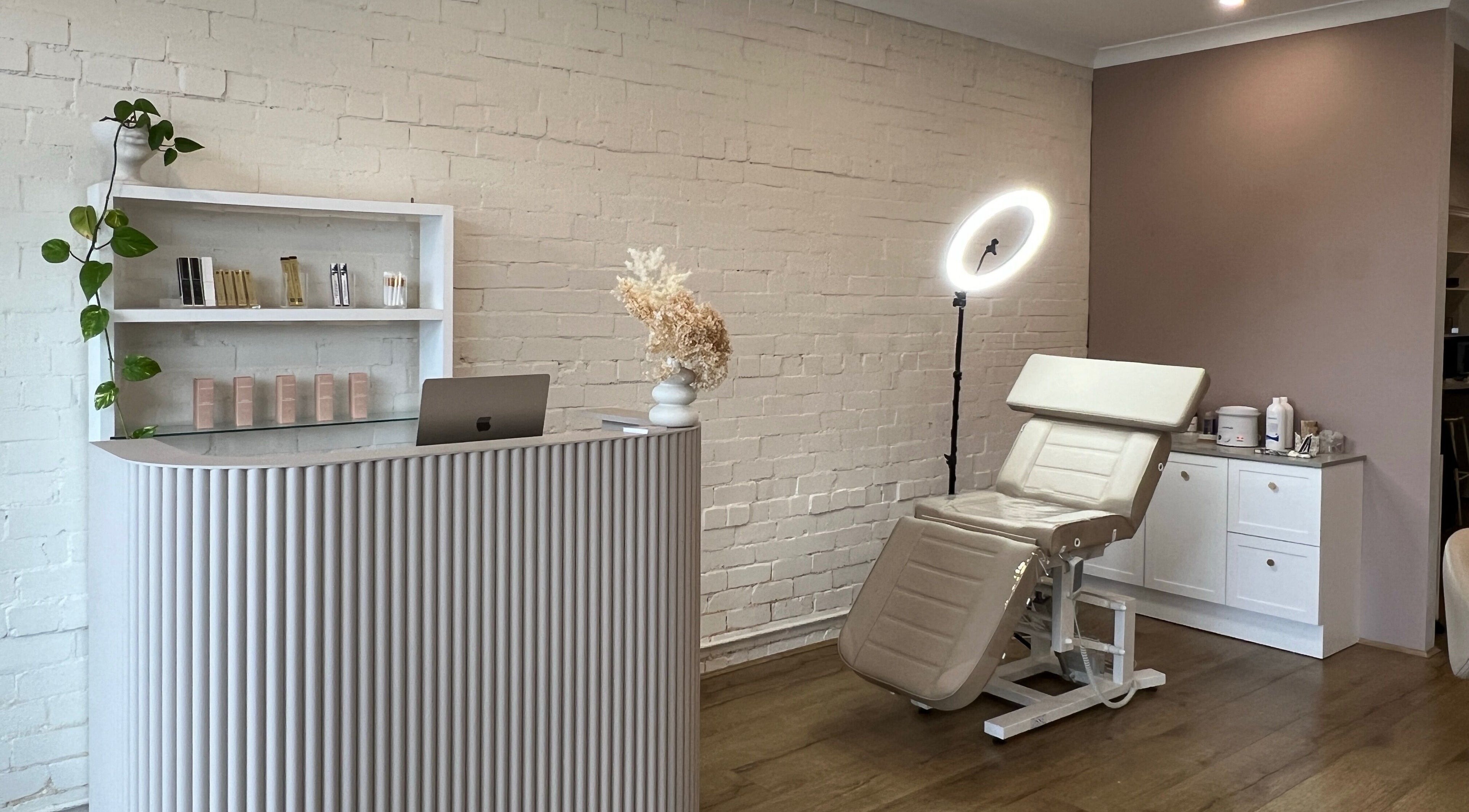 Ona Lash and Brow Bar in Melbourne, Victoria, AU features a modern reception and treatment chair with soft lighting.