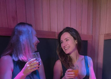 Two women enjoying drinks at Chill Wellness, Auckland, Auckland, NZ. Cozy, peaceful ambiance.